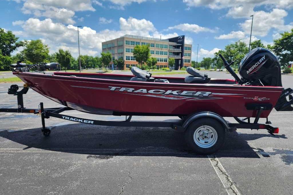 2025 Tracker Super Guide V-16 T boat on trailer, parked outdoors under blue sky.