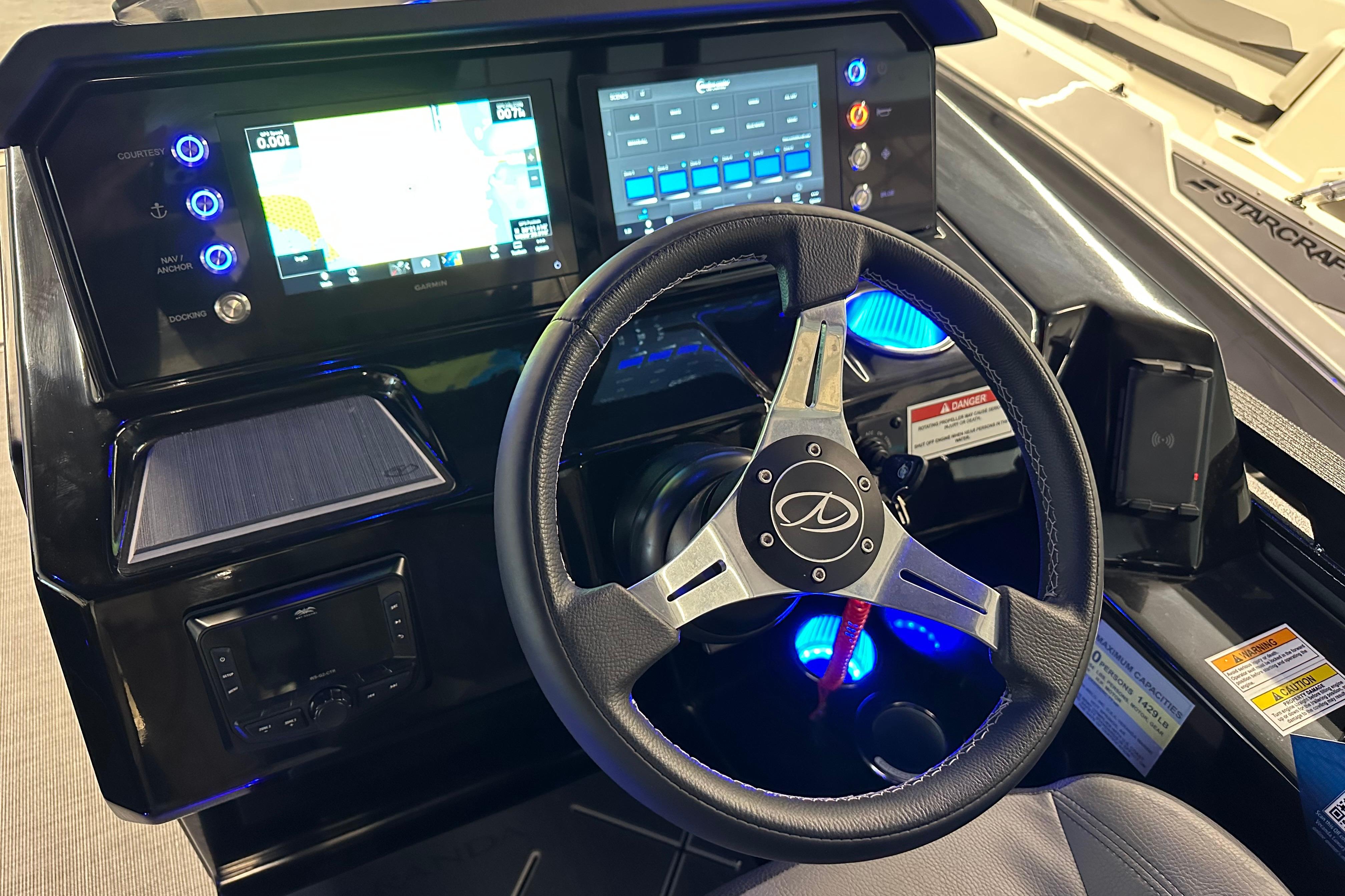 2025 Veranda VX 27 DCRC boat dashboard with steering wheel and digital controls.