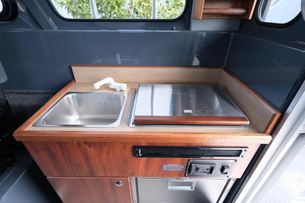 2024 Hewescraft 250 Explorer interior kitchen with sink and stove.
