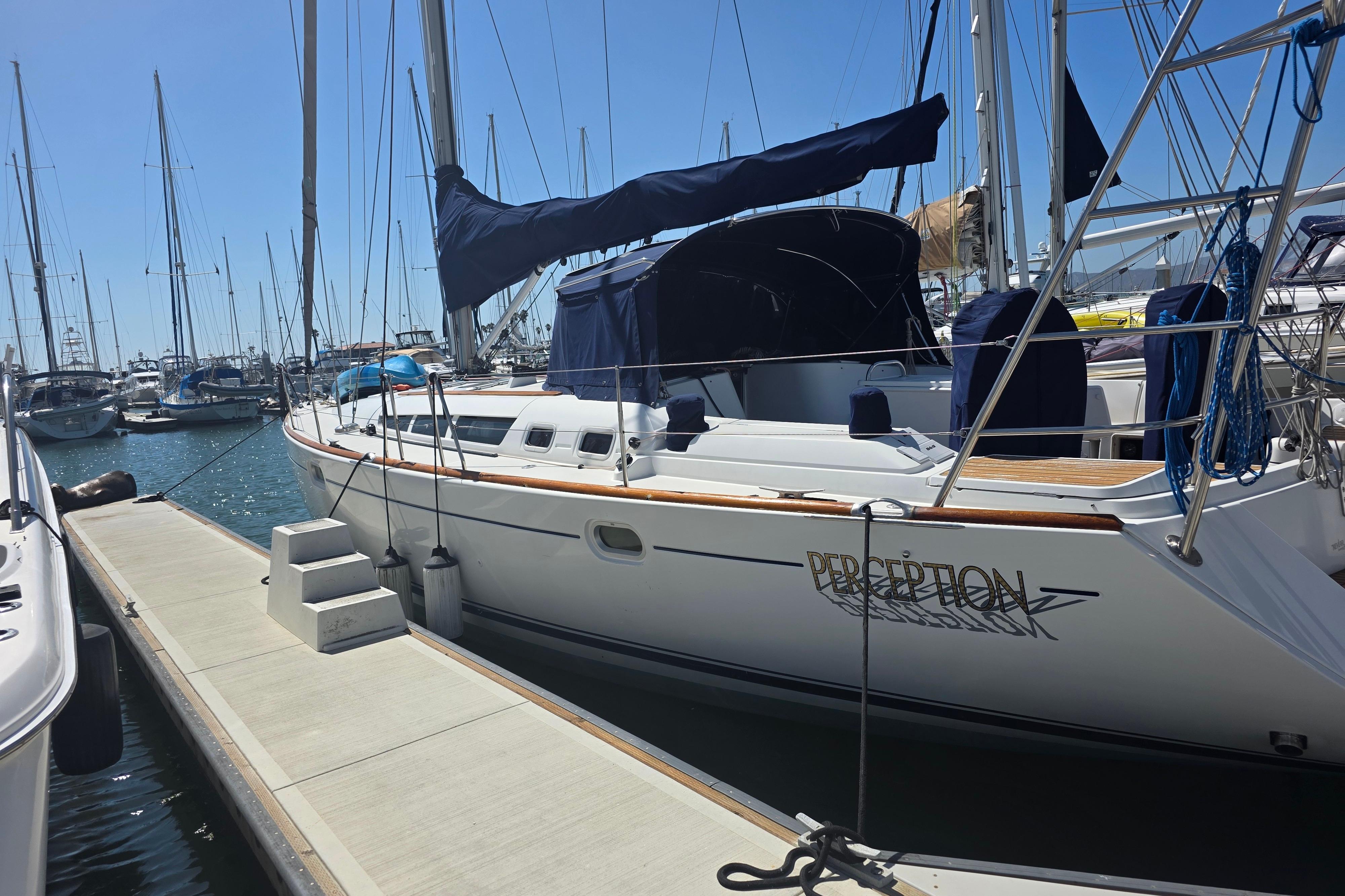 2007 Jeanneau 49 Performance sailboat docked at a marina under clear blue skies.