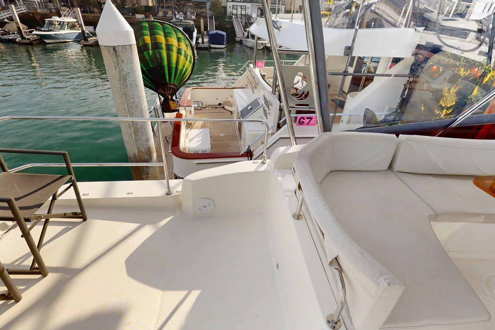 2021 Beneteau Swift Trawler 35, spacious deck with seating, docked at marina.
