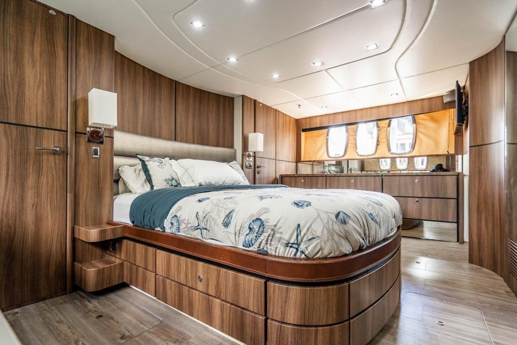 Luxurious Fairline 68 yacht bedroom interior, 2020 model, featuring elegant wood finishes and modern design.