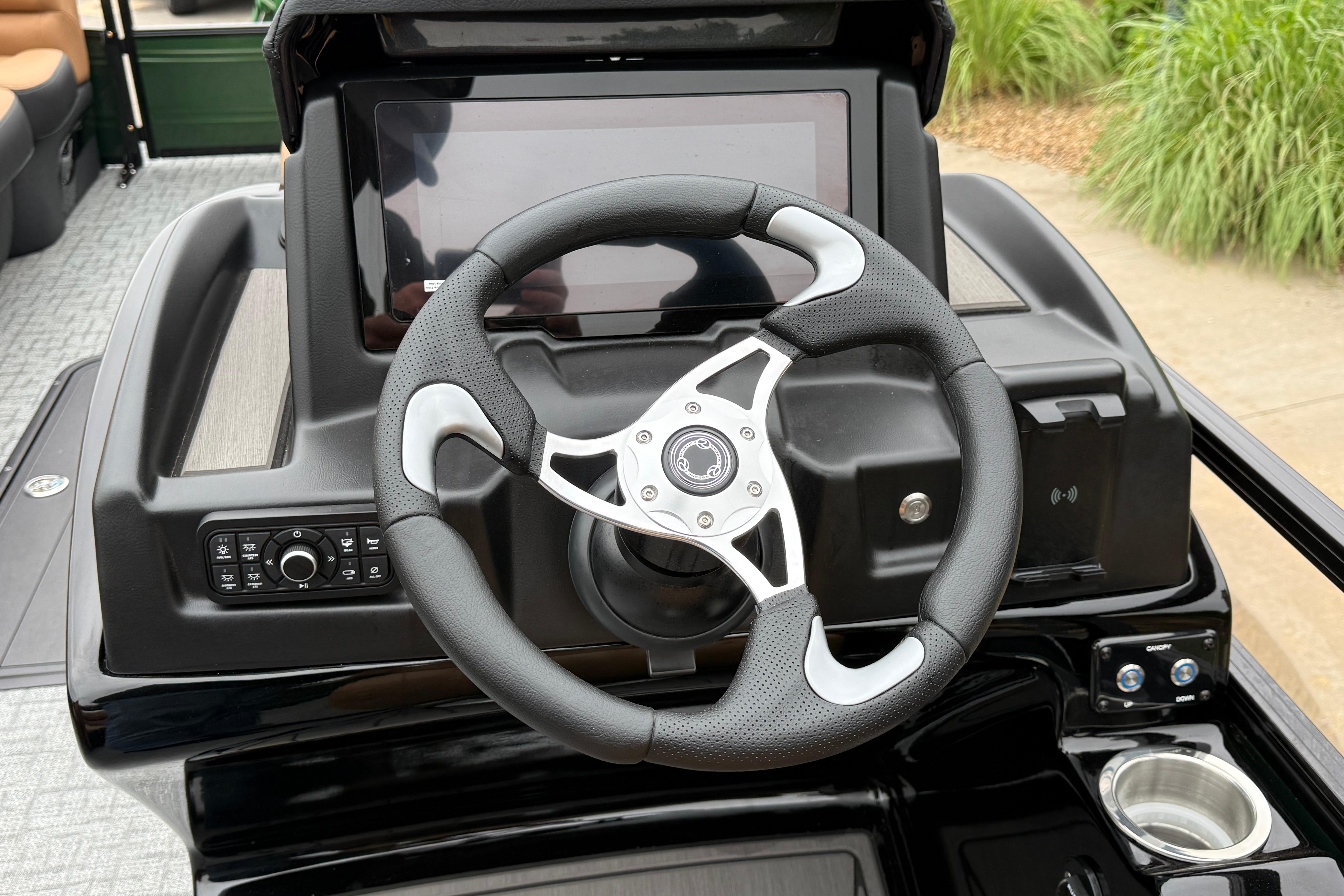 Steering console of 2026 Regency 250 DL boat with touchscreen and controls.