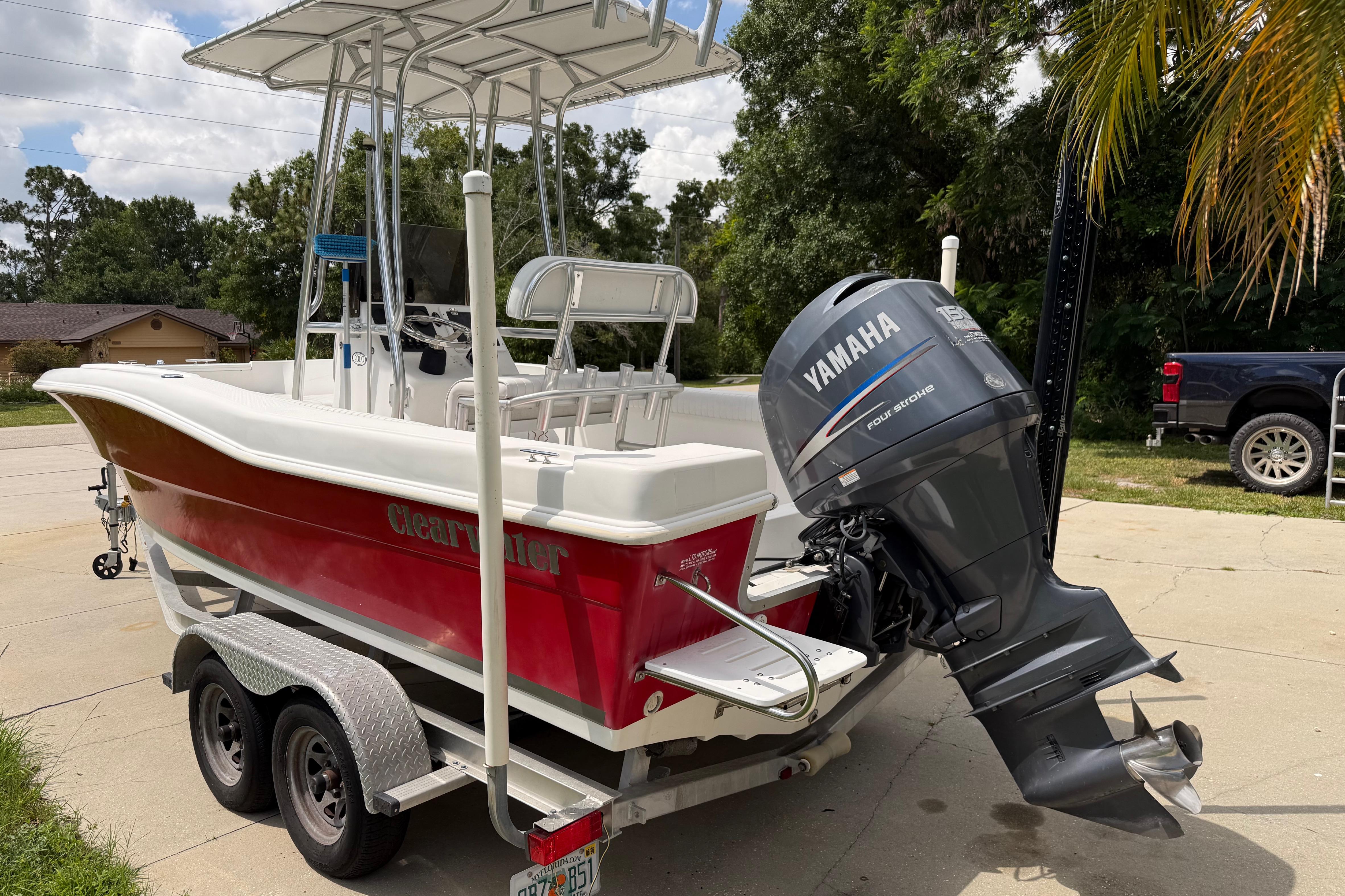 Red 2012 Clearwater 2000 Center Console boat with Yamaha outboard motor on trailer.