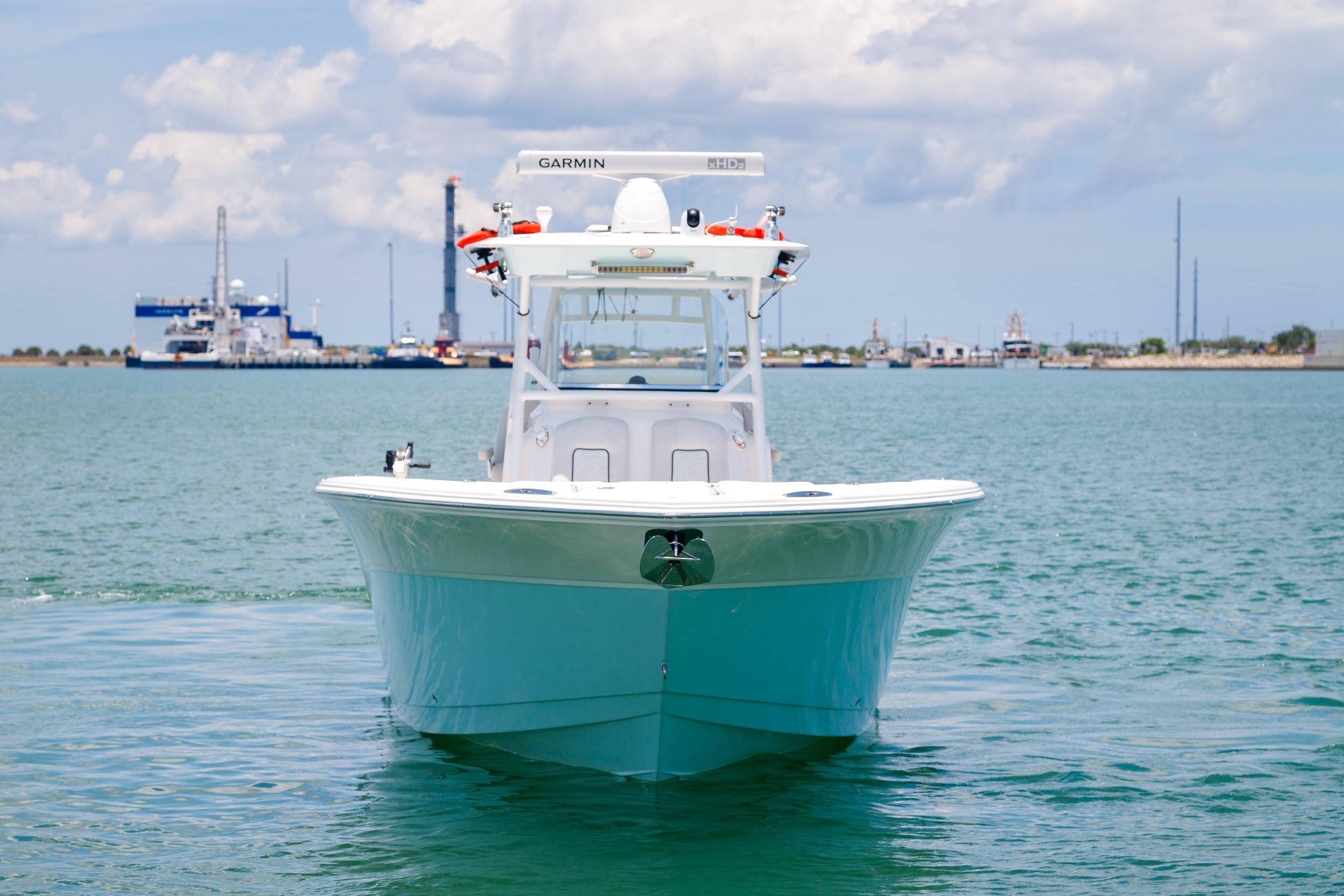 2021 Sea Fox 328 Commander boat on calm water with industrial background.