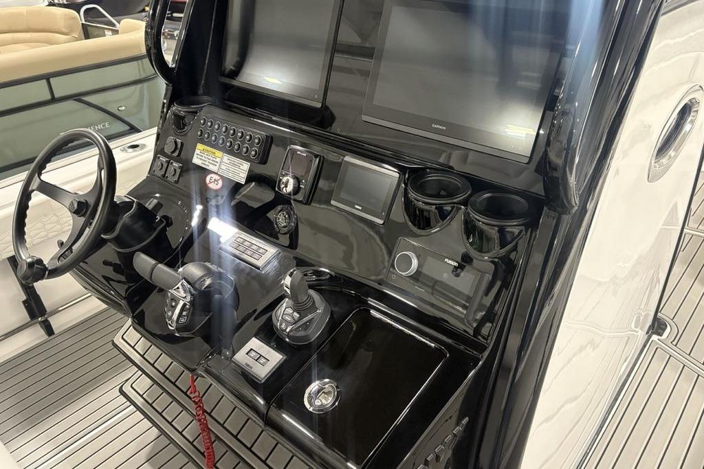 2026 Tidewater 3100 Carolina Bay boat dashboard with steering wheel and electronic controls.