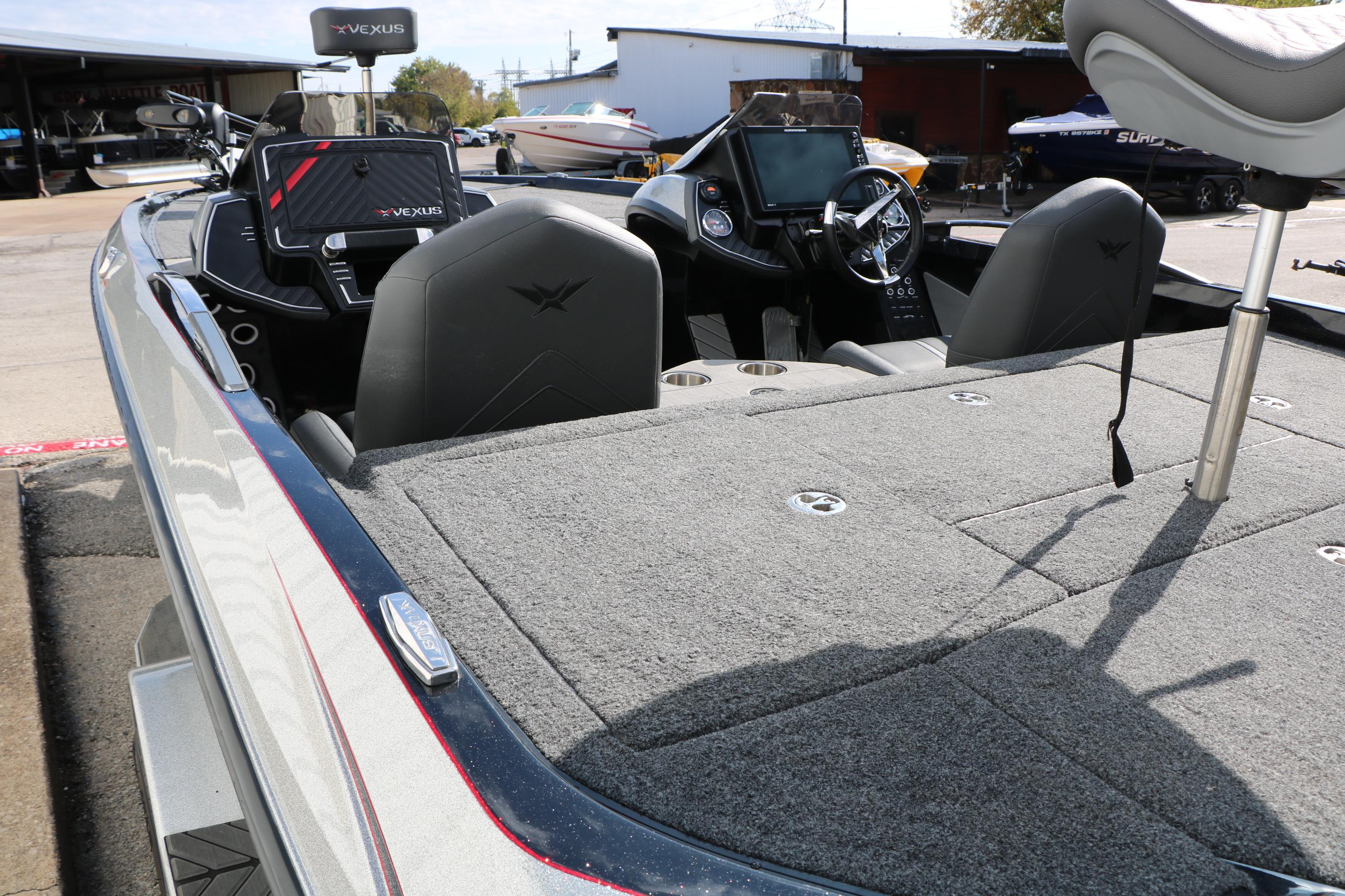2022 Vexus VX21 boat interior with seating and control panel, docked outdoors.