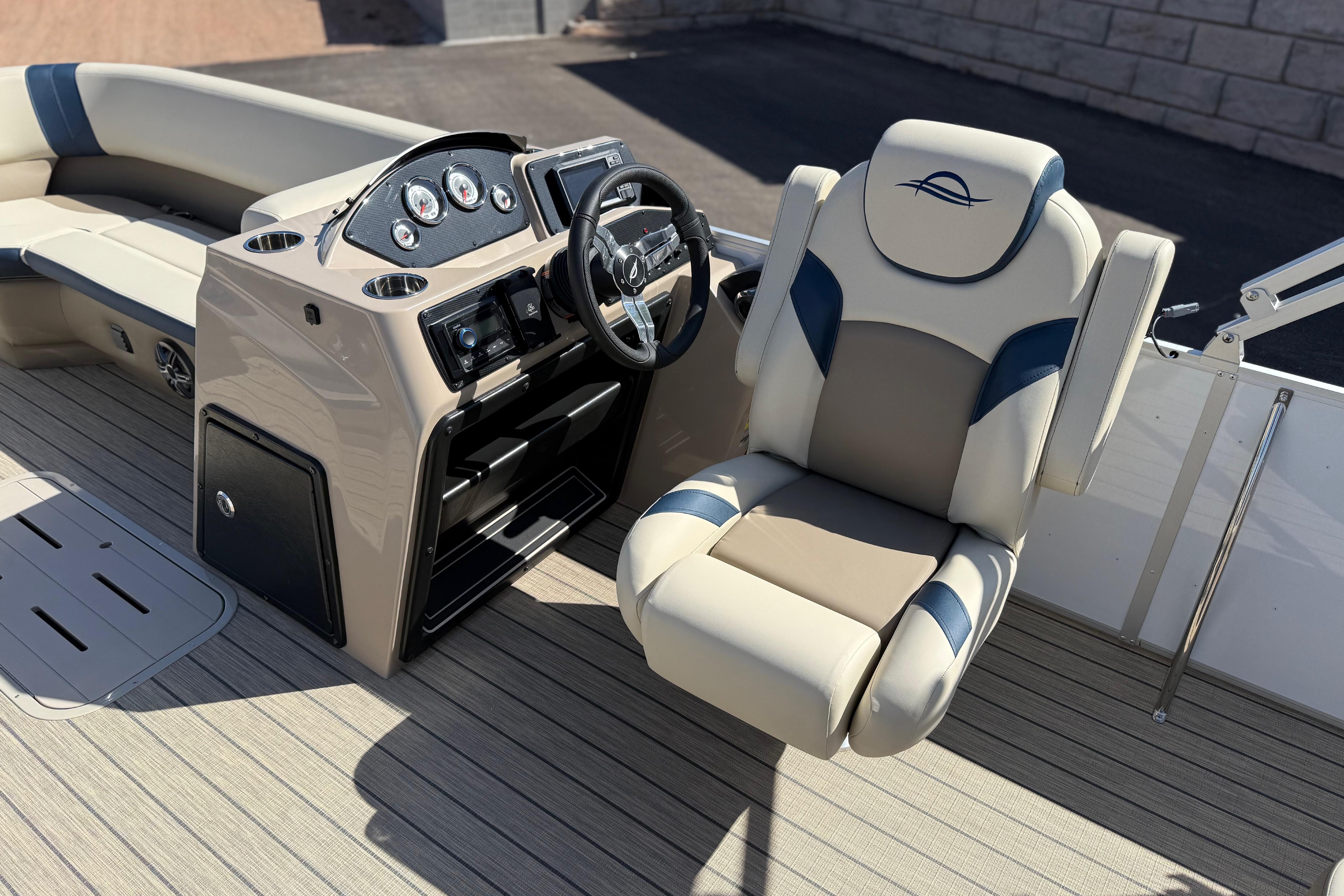 2026 SunCatcher Select 322SL boat interior with captain's chair and control panel.