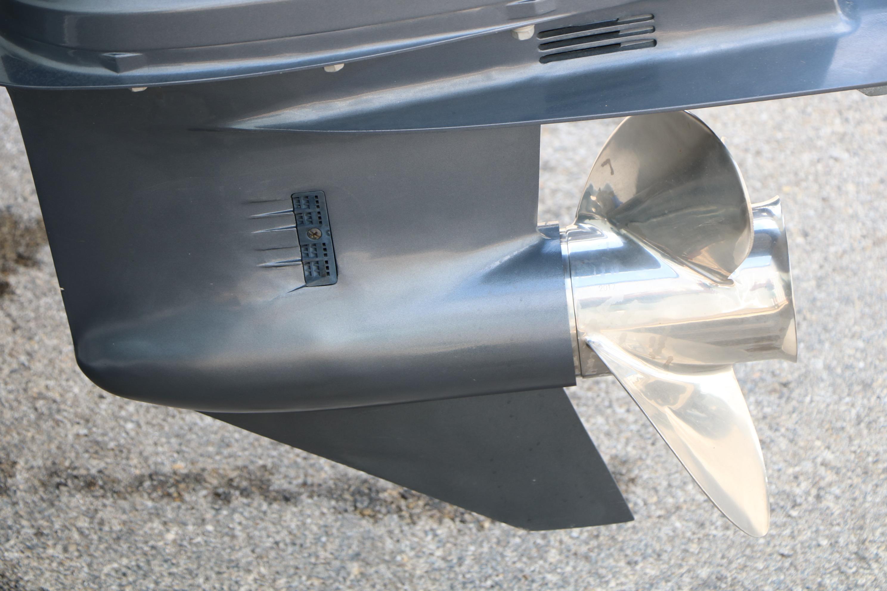 Close-up of a 2017 Sea Fox 226 Traveler boat propeller on a concrete surface.