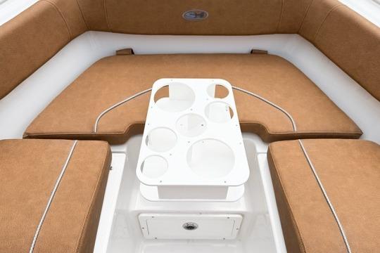 2026 Sea Hunt Ultra 255 SE boat interior with cushioned seating and cup holders.