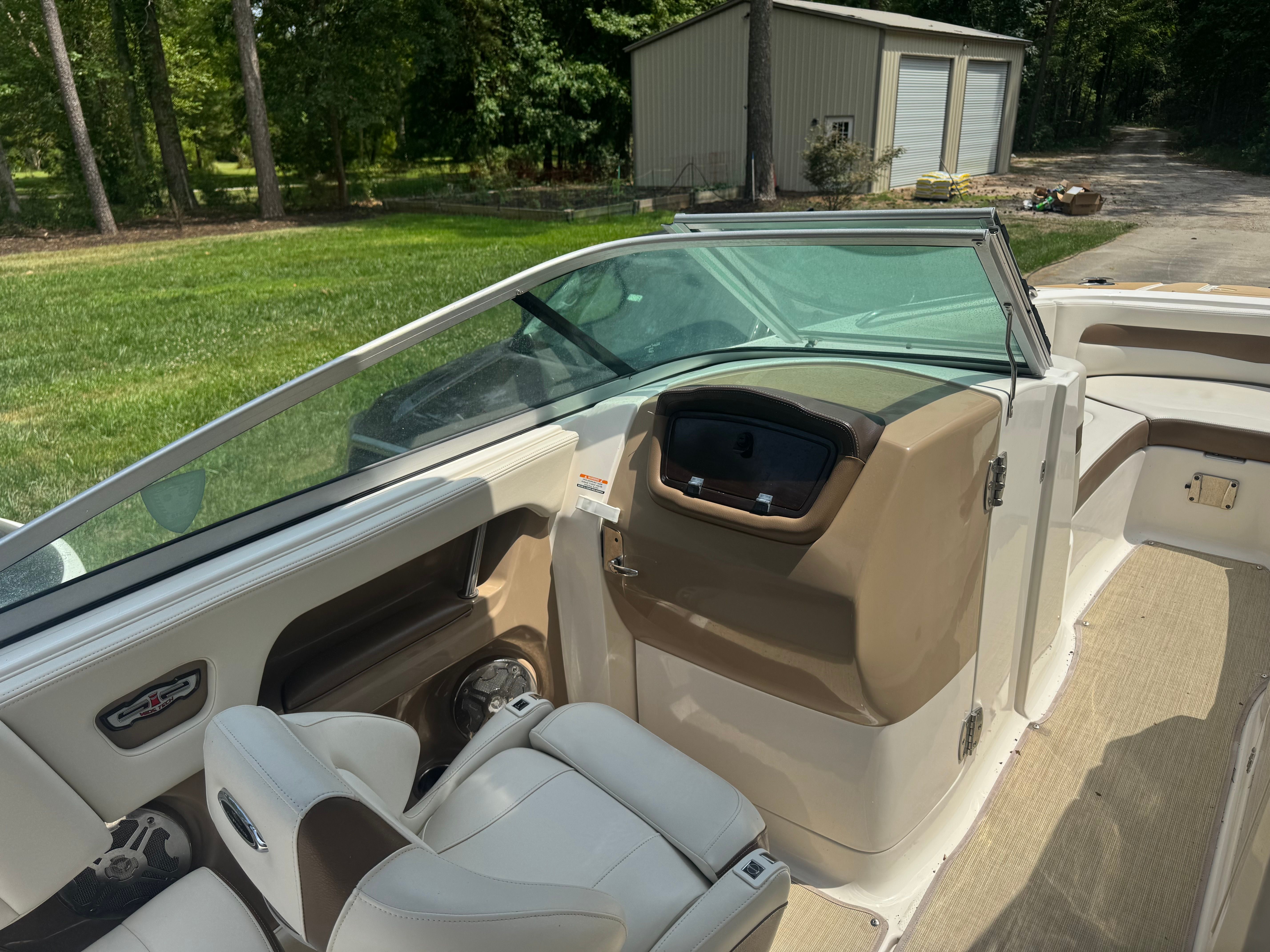Interior of a 2016 Chaparral 246 SSi boat, beige and brown.