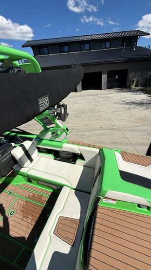 The image shows the interior of a 2018 Nautique Super Air Nautique G23 with green and white seating.
