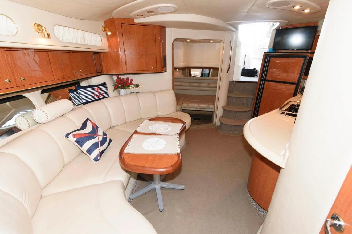 Luxurious interior of a 1999 Sea Ray Sundancer 400 yacht with elegant seating and wood finishes.