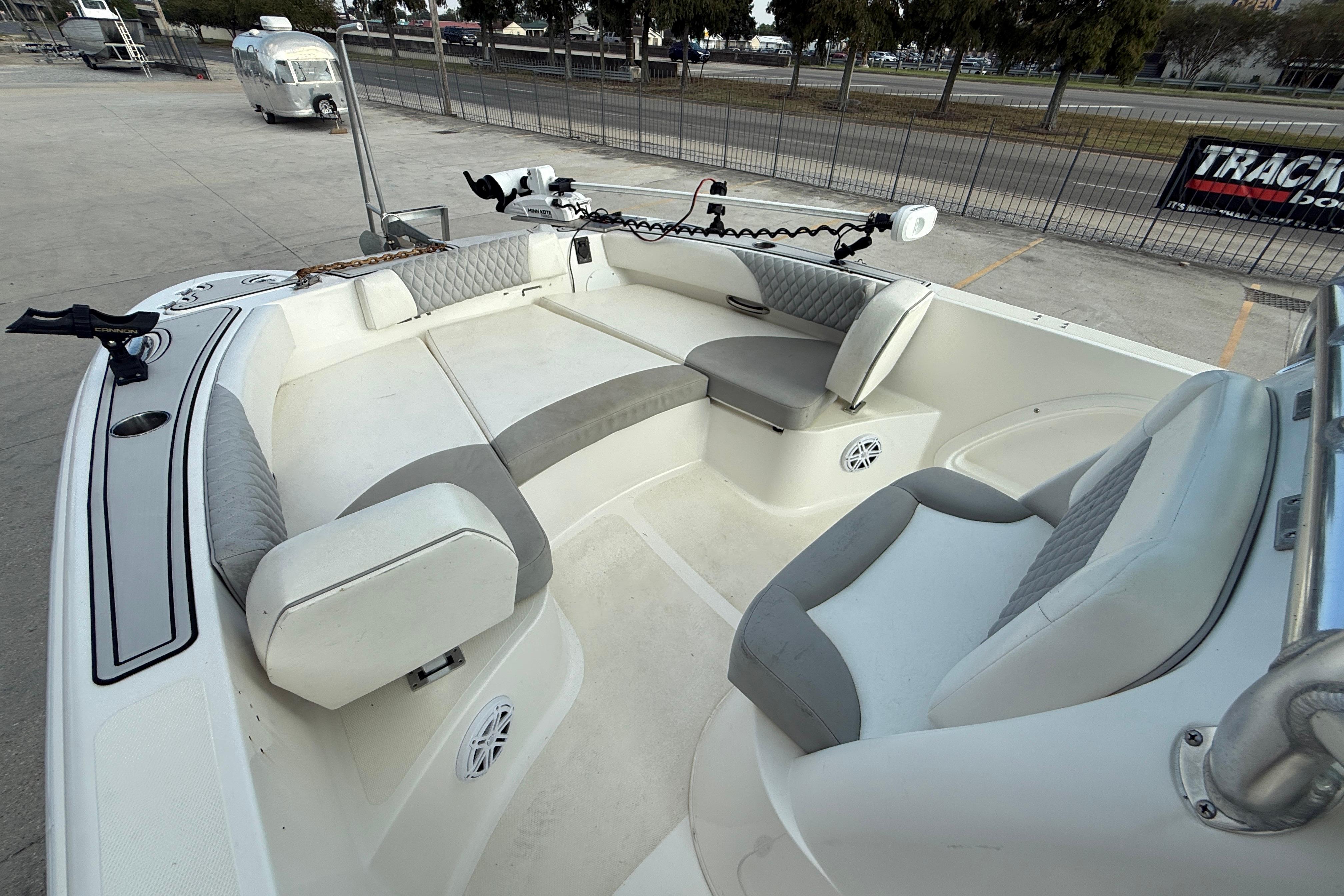 2020 Twin Vee 240 GFX CC boat interior with cushioned seating and fishing rod holders.