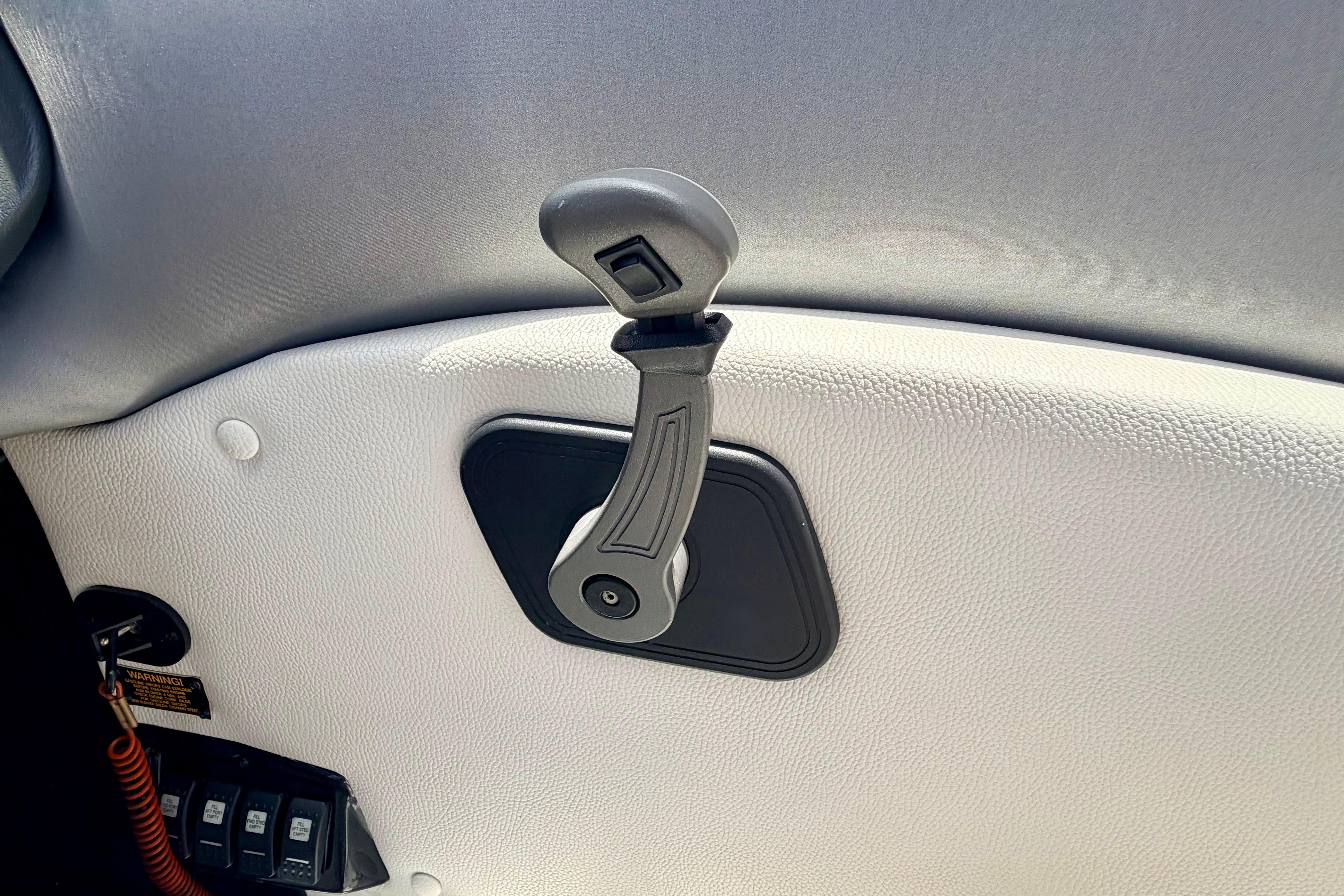 Interior handle of a 2014 Tigé R20 boat, featuring textured white upholstery.