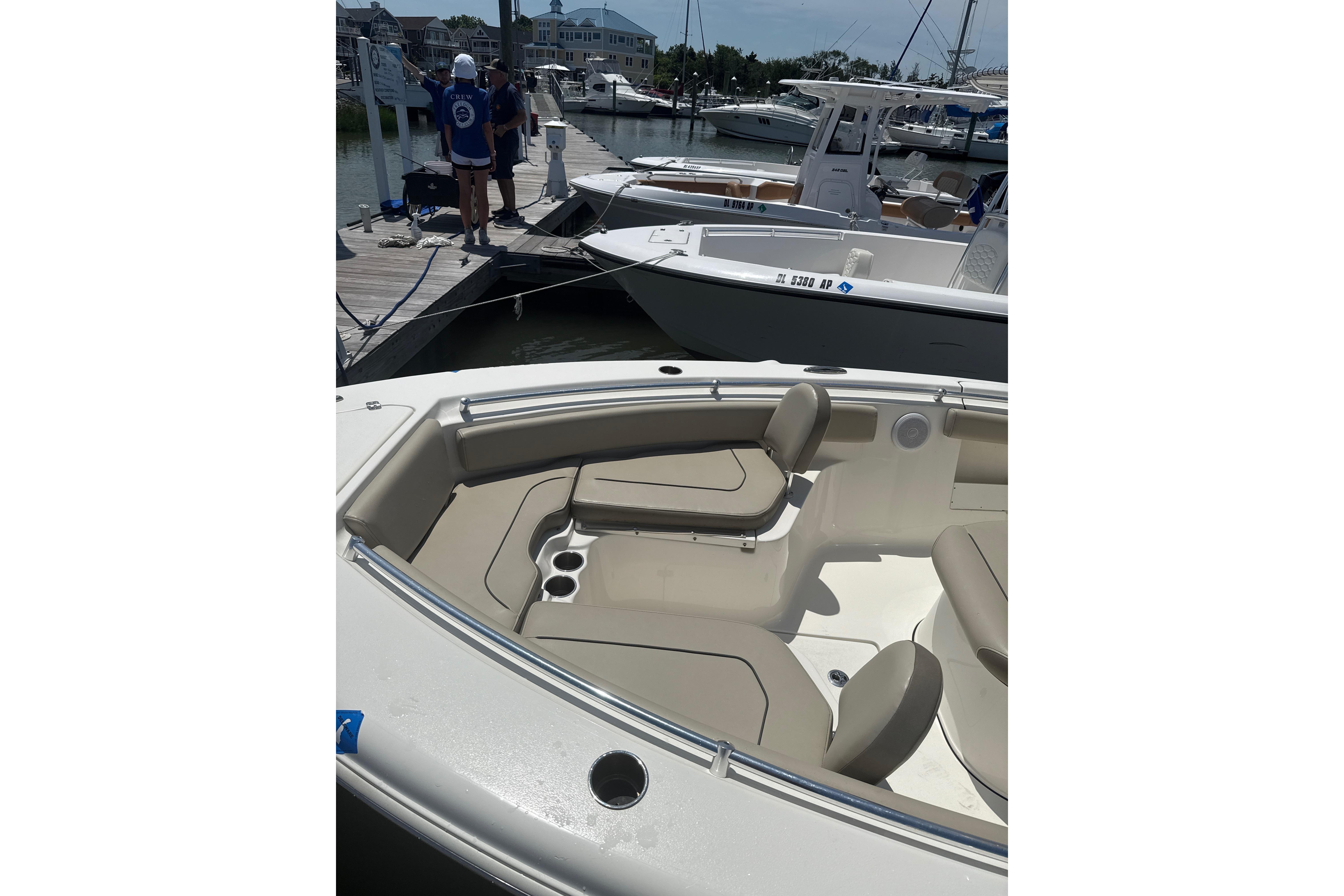 2024 Key West 239 FS boat docked, featuring spacious seating and sleek design.