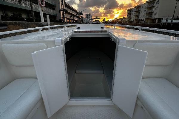 Open cabin of 2001 Concept 30 PF Sport boat at sunset, docked near buildings.