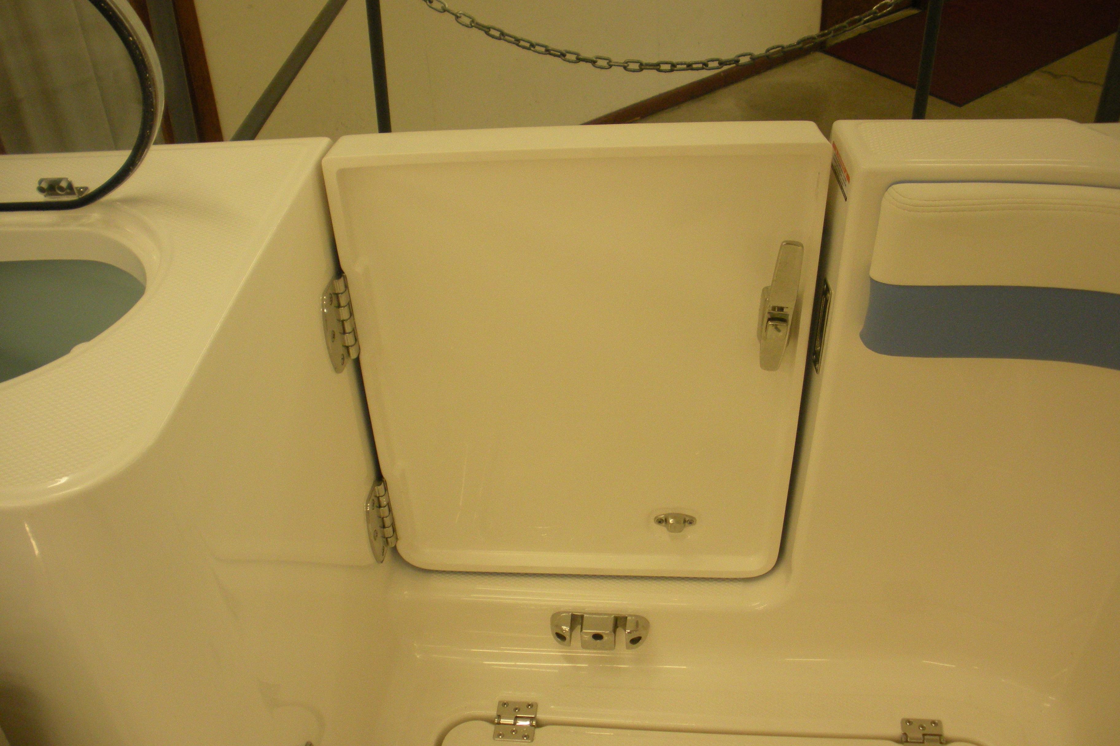 2026 Robalo R257 Dual Console boat storage compartment with secure latch.