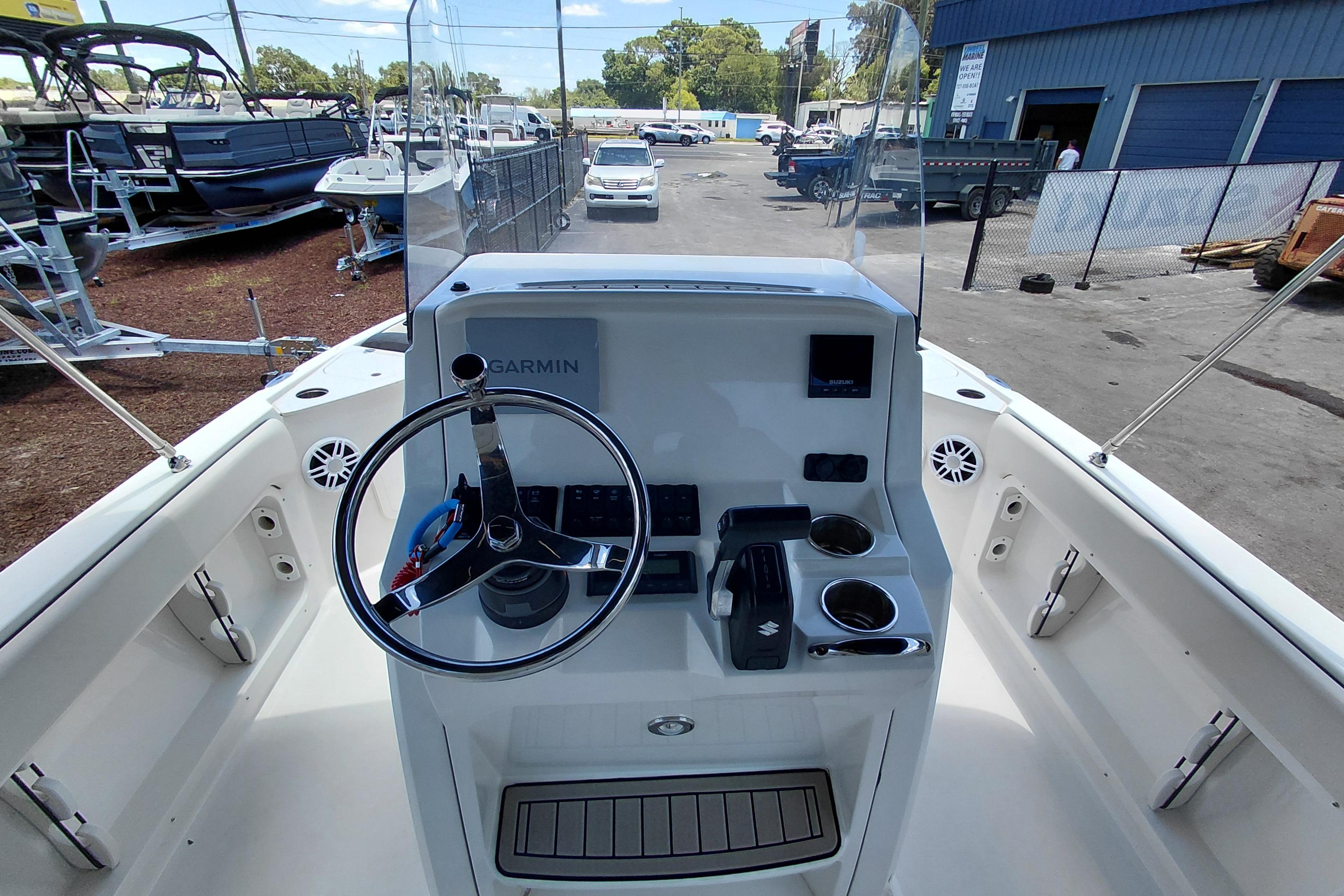 2023 Stingray 206 CC boat dashboard with steering wheel and Garmin navigation system.