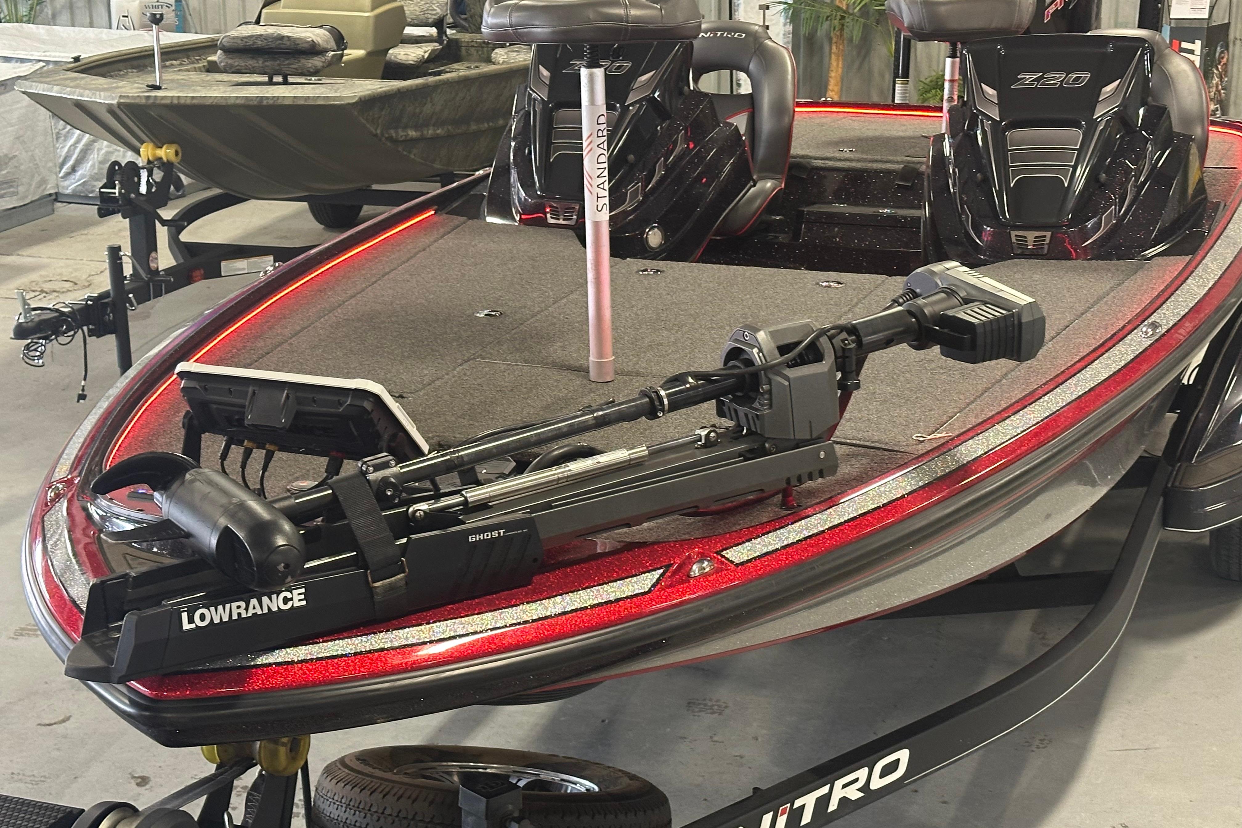 2022 Nitro Z20 Pro boat with Lowrance Ghost trolling motor, featuring sleek red design.