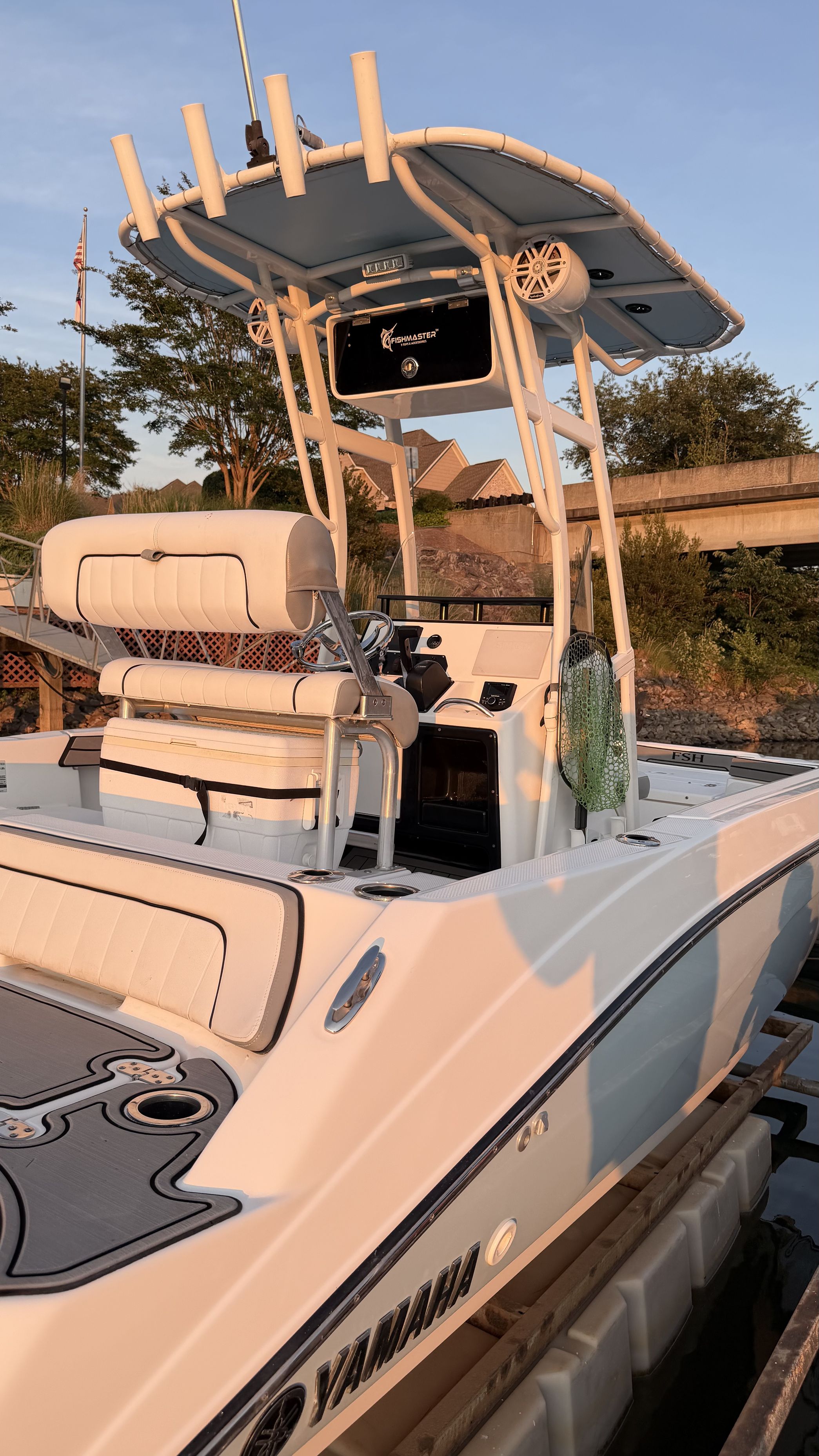 A 2019 Yamaha 190 FSH Sport boat docked. It features an elevated helm station.