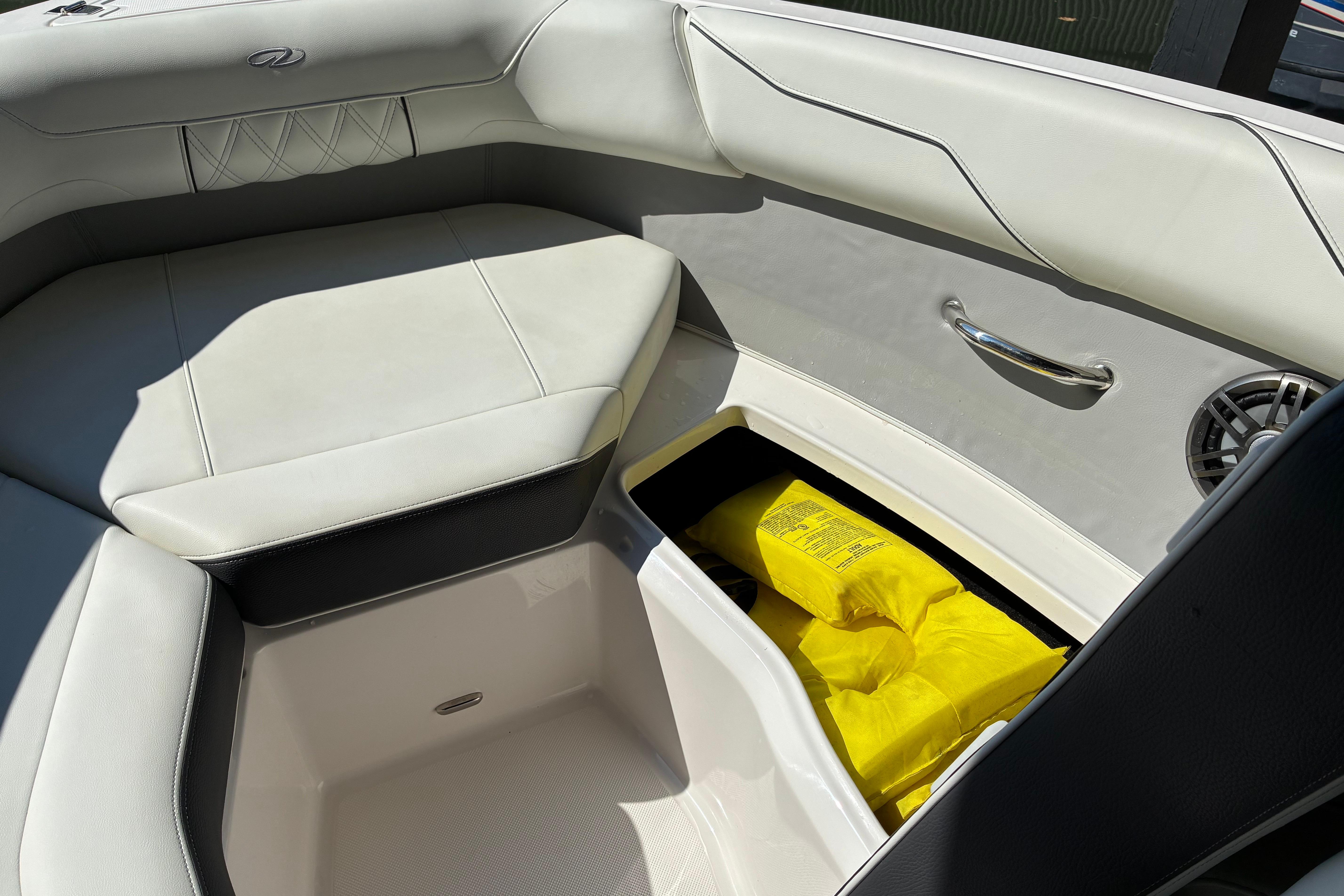 2025 Regal LS2 boat interior with storage compartment and yellow life jackets.
