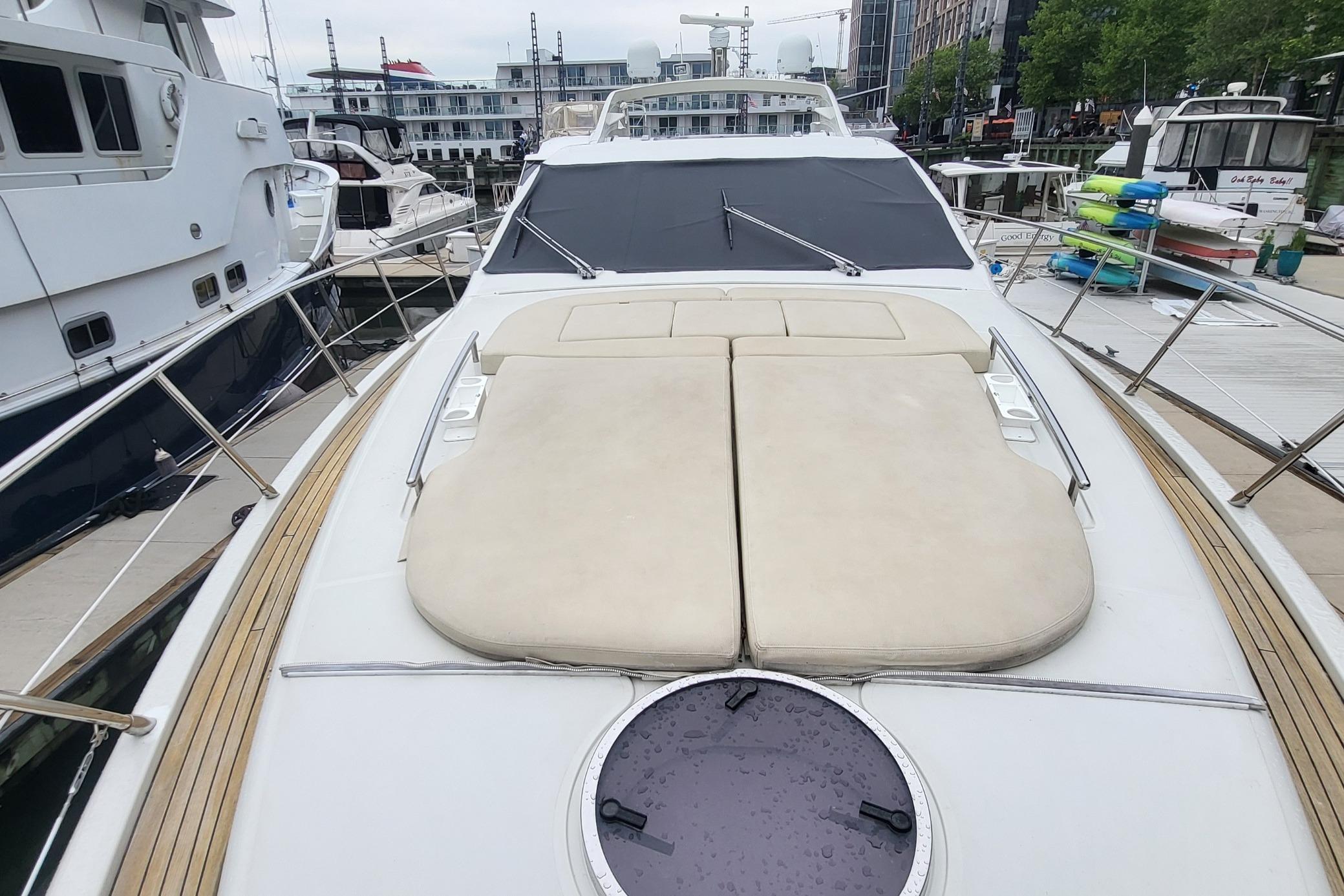 2007 Azimut 68S yacht with sunbathing deck, docked at a marina.