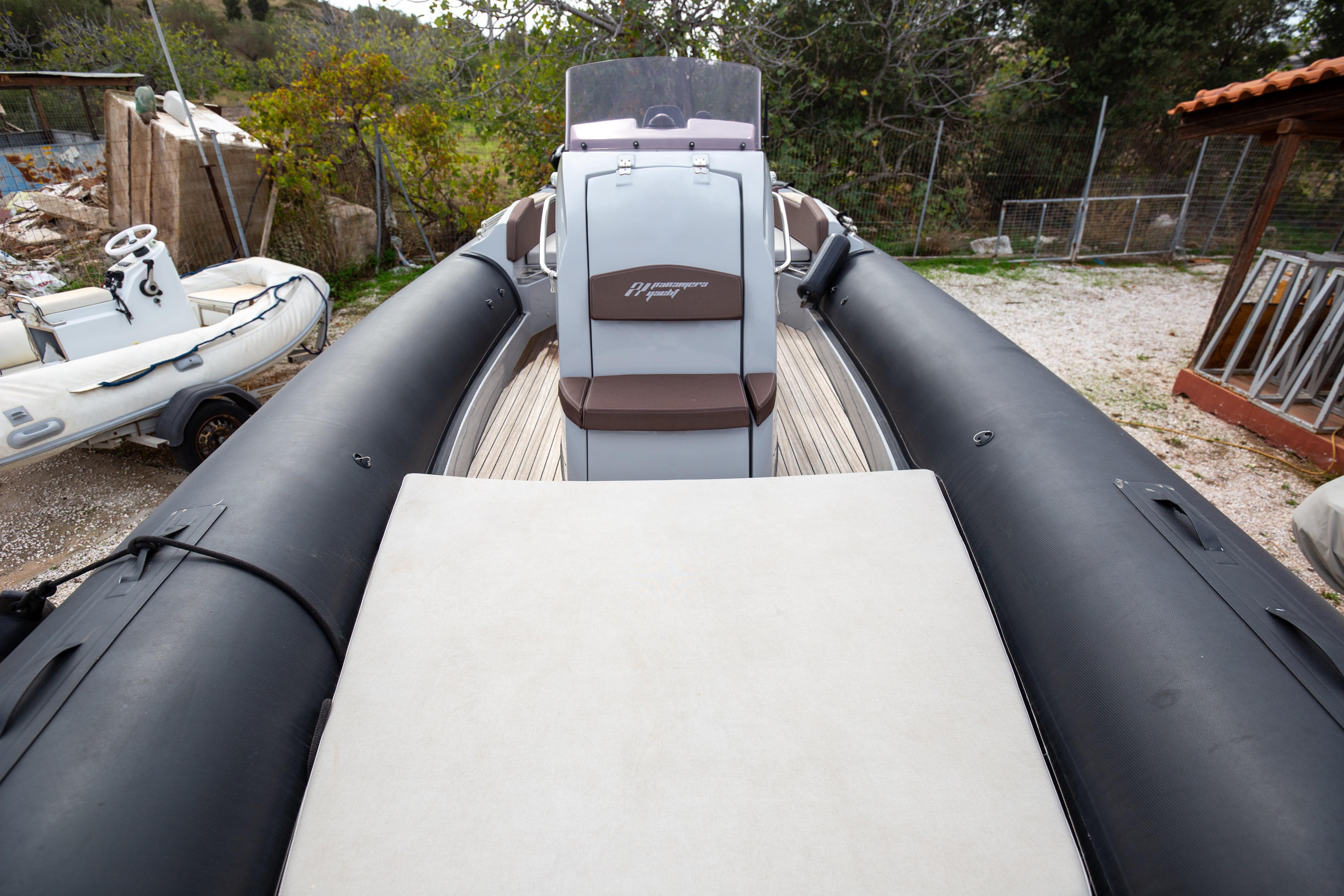 2021 Panamera Yacht PY80, sleek design, docked outdoors, featuring black inflatable sides.