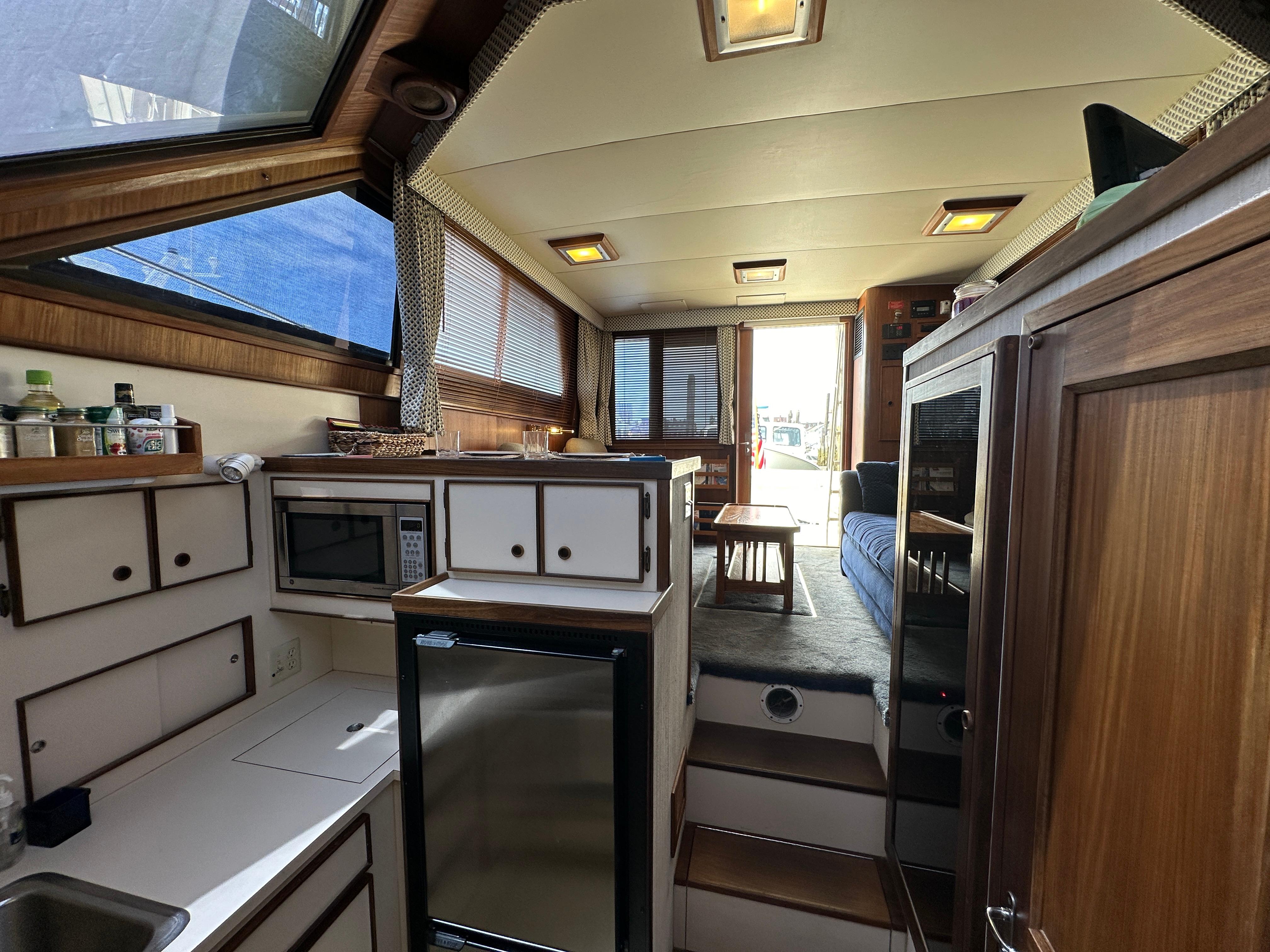Interior of 1985 Hatteras 36 Convertible yacht with kitchen and seating area.