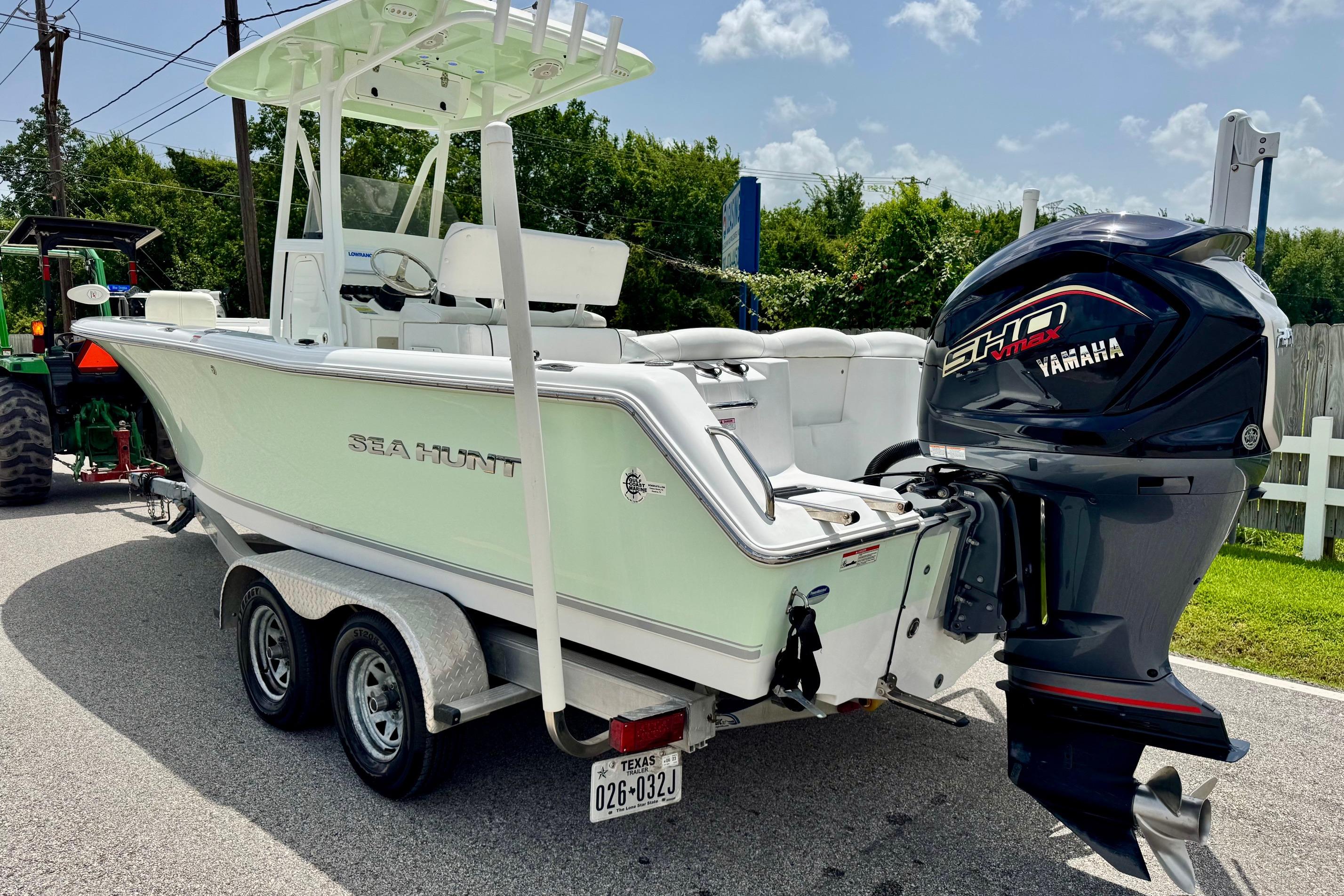 2015 Sea Hunt Ultra 234 boat with Yamaha engine on trailer, parked outdoors.