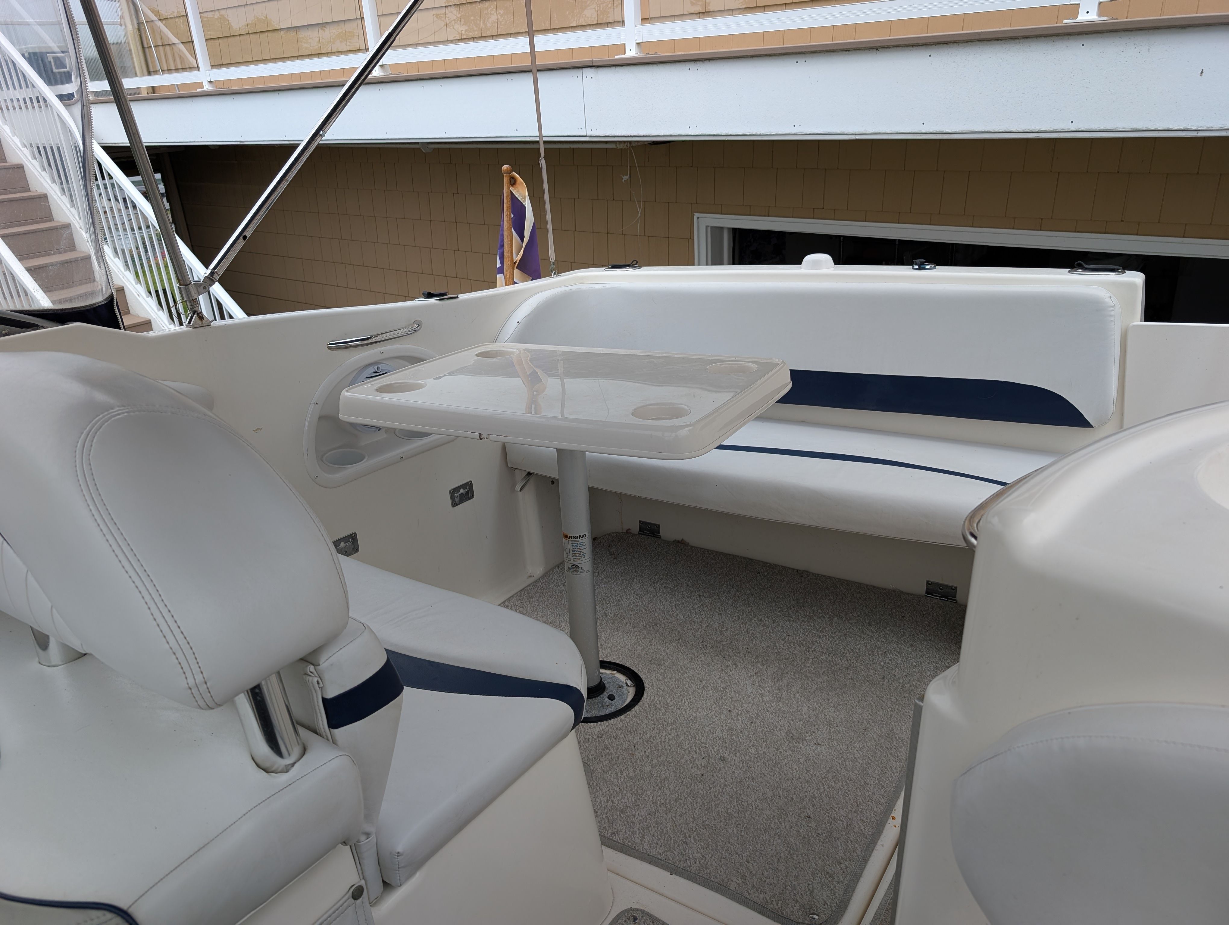 Interior of a 2006 Glastron GS boat with seating area and table.