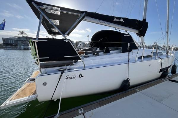 2025 Hanse 360 sailboat docked in marina, featuring sleek design and modern amenities.