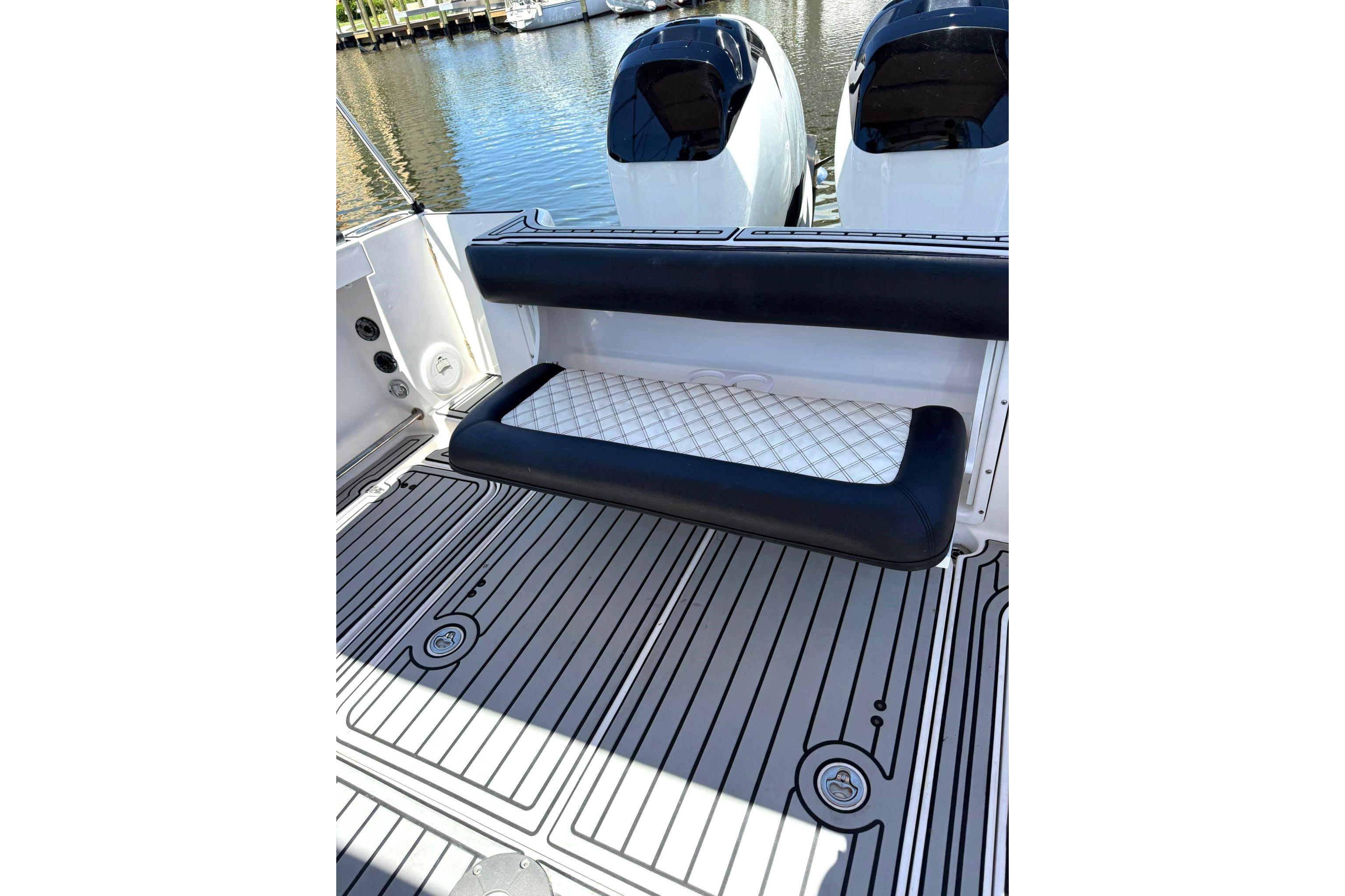 2006 Pro-Line 32 Express boat with cushioned seating and twin engines, docked by the water.
