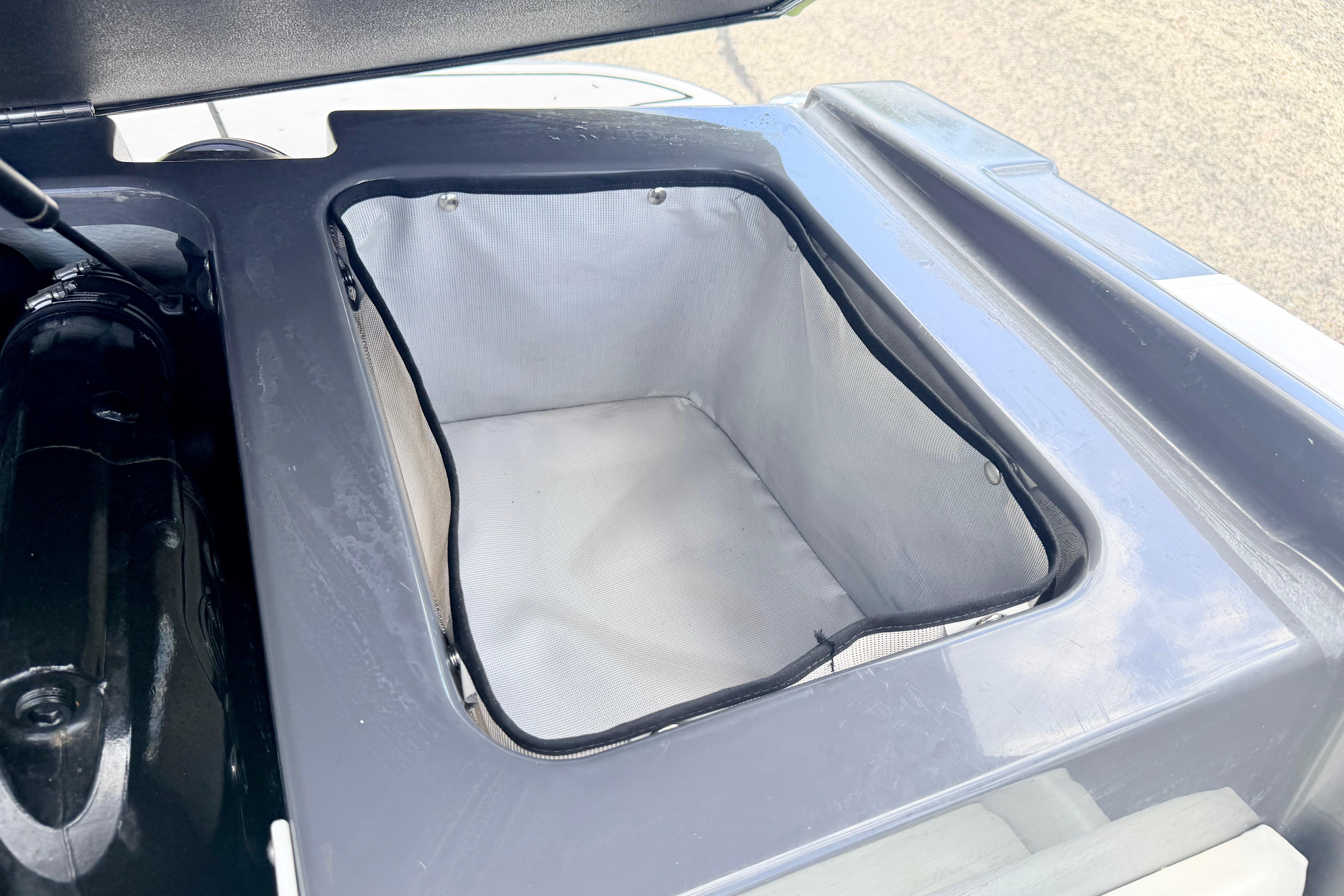 Storage compartment of a 2018 Glastron GT 185 boat, featuring a clean interior.