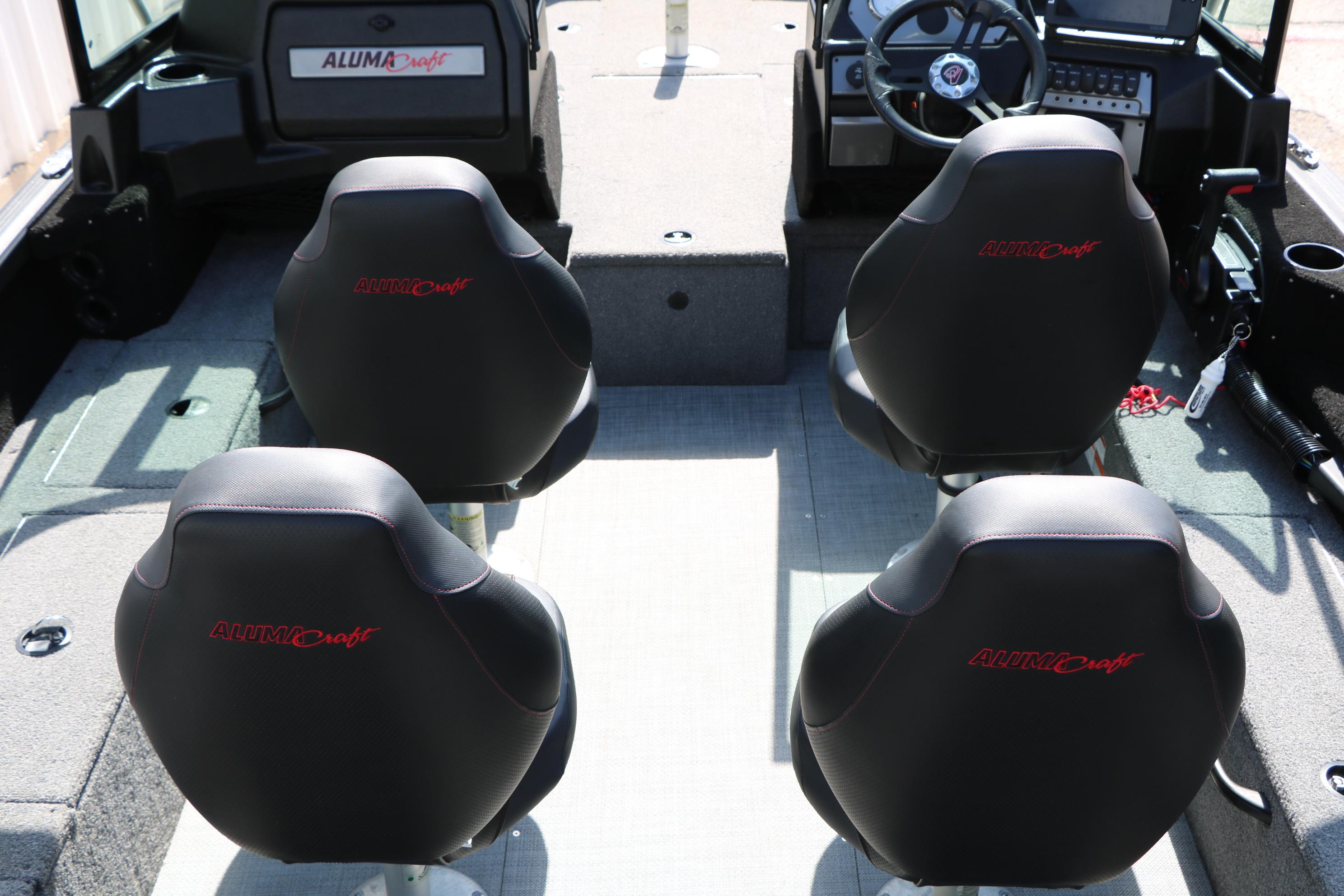 2023 Alumacraft Competitor FSX 185 boat interior with four black seats and steering console.
