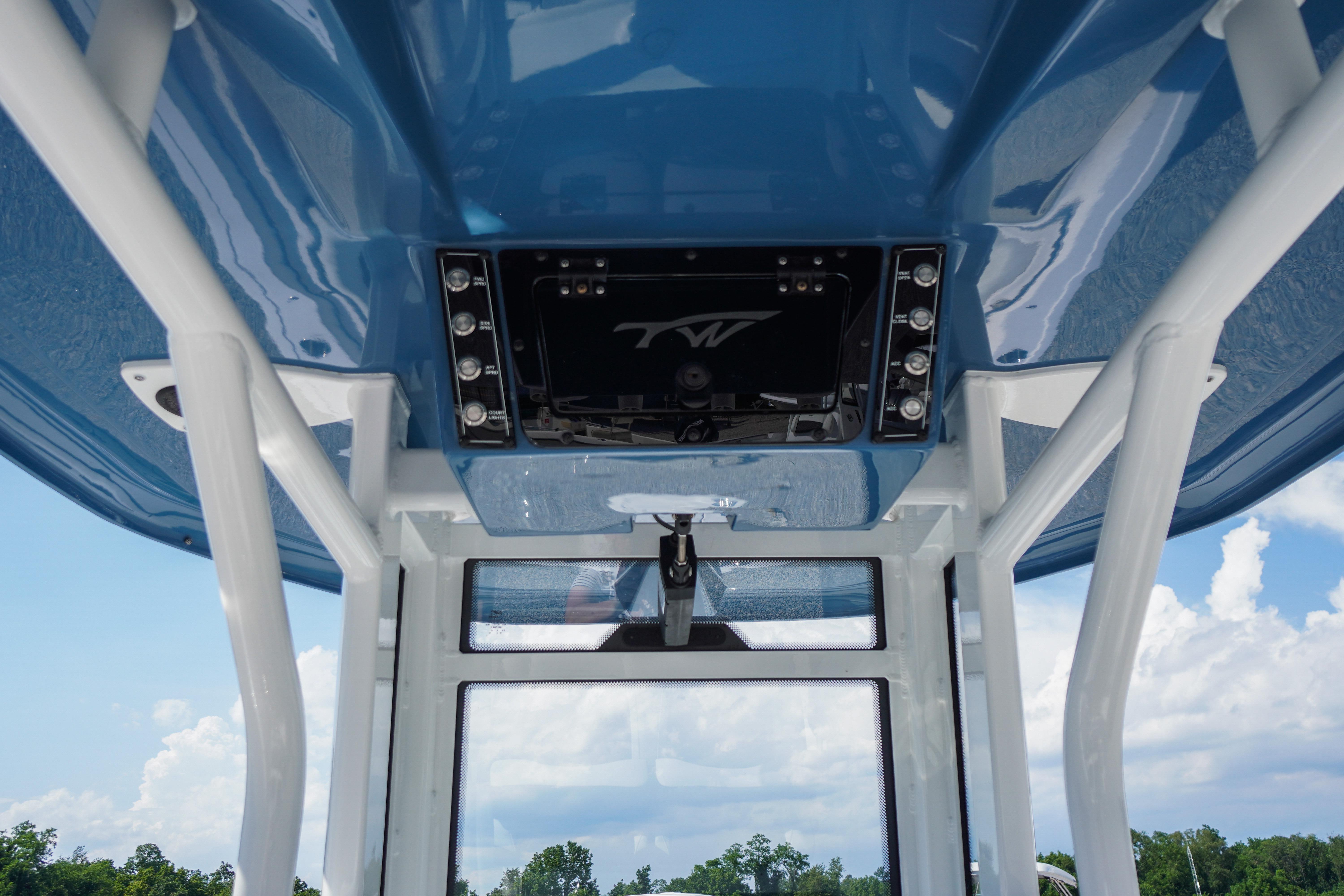 2025 Tidewater 232 SS boat console with blue canopy and control panel.