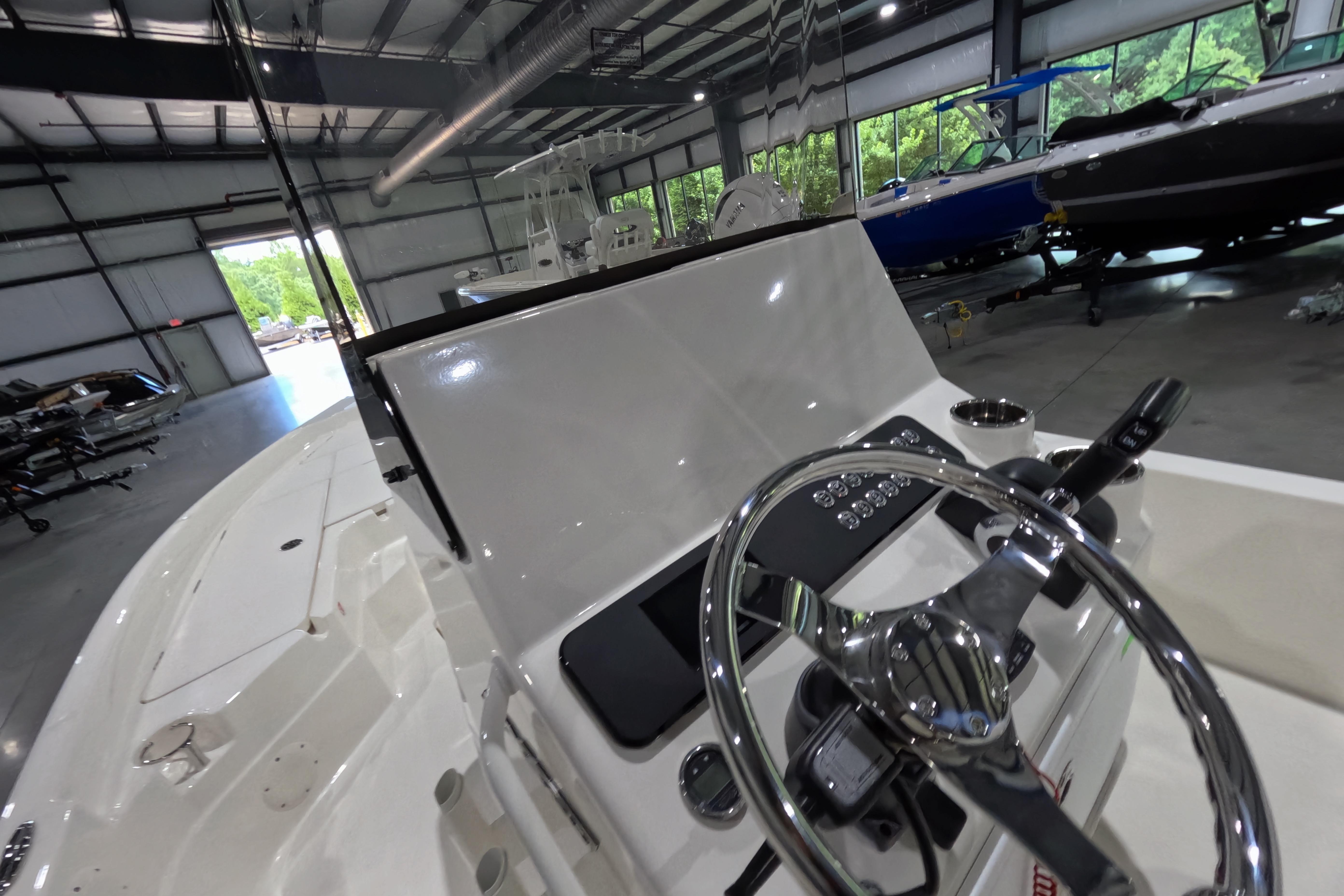 Interior view of a 2026 Skeeter SX230 boat in a showroom.