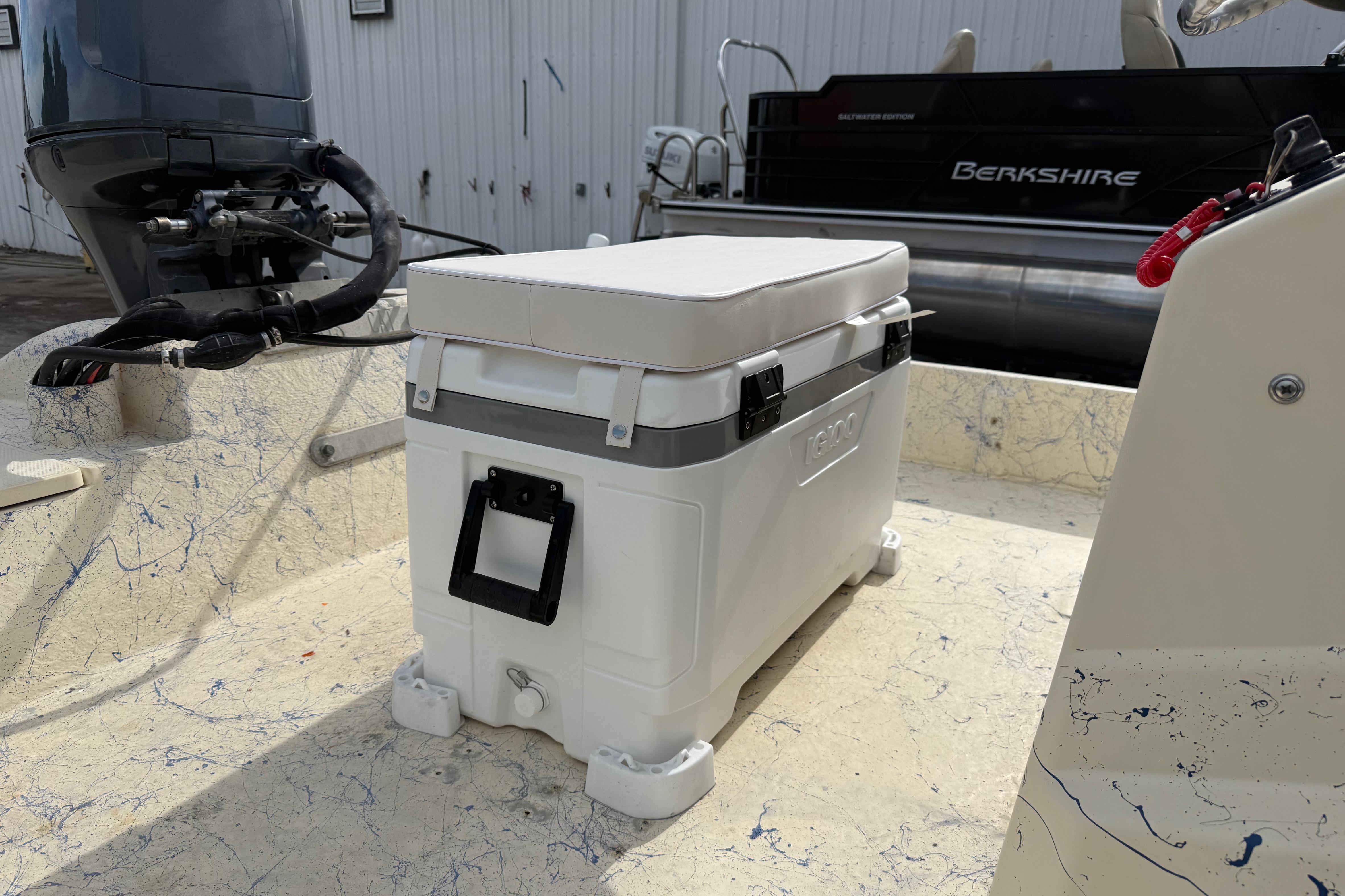 2007 Flats Cat 19 boat interior with cooler and outboard motor.