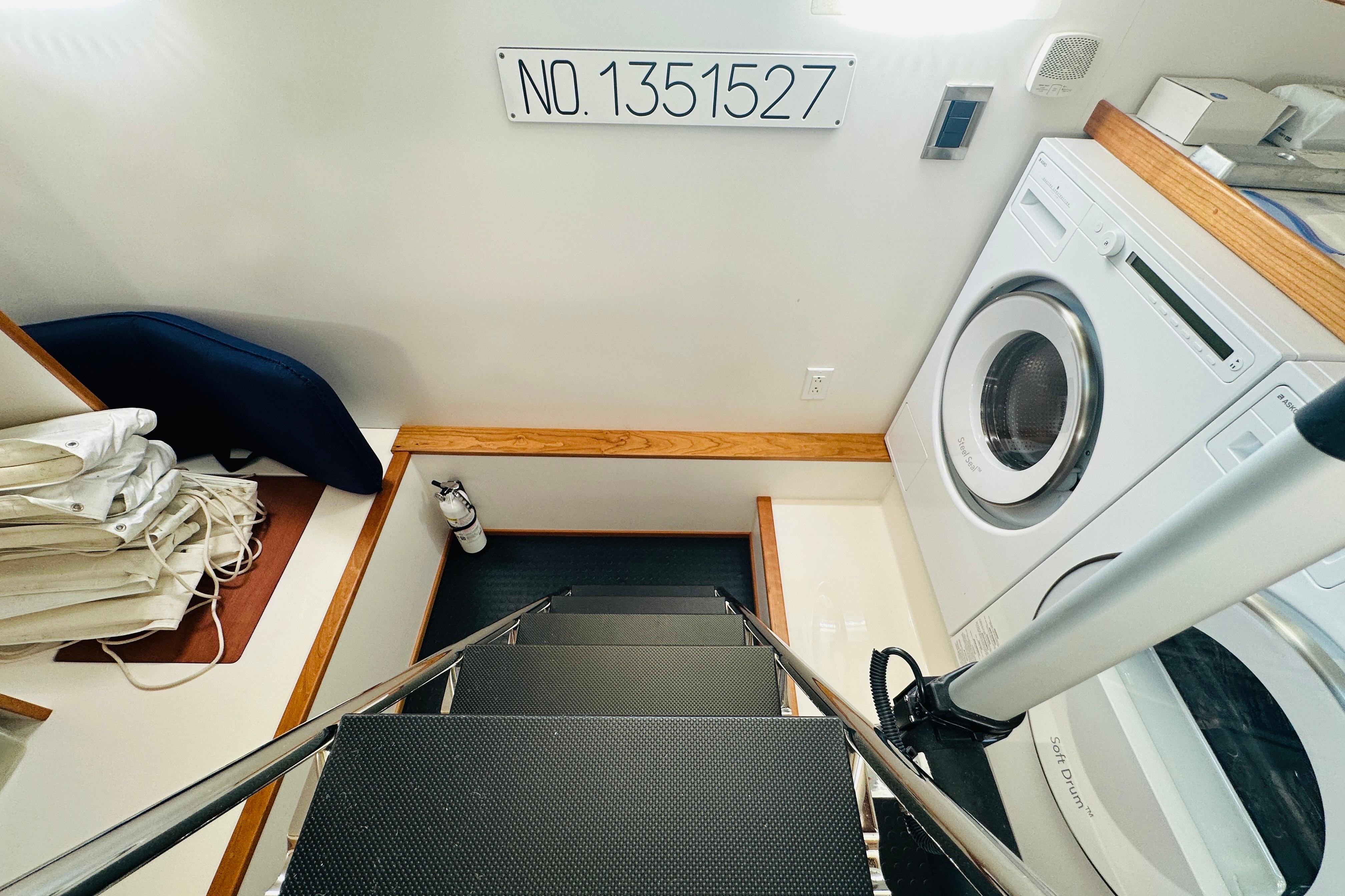 Laundry area on 2025 Sabre 48 Salon Express yacht with washer, dryer, and storage.