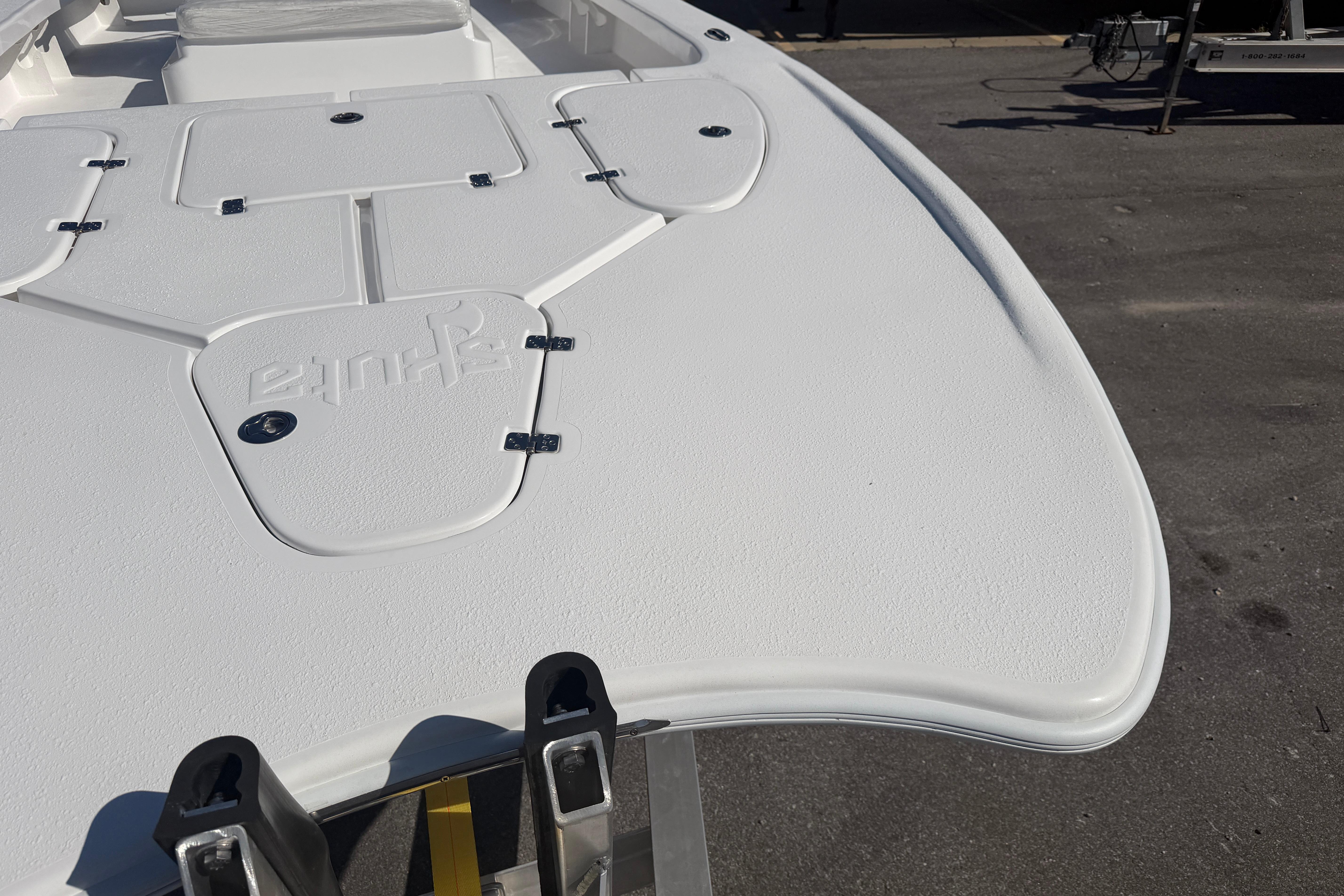 2026 Skuta 24 Cat boat deck, featuring sleek design and storage compartments.