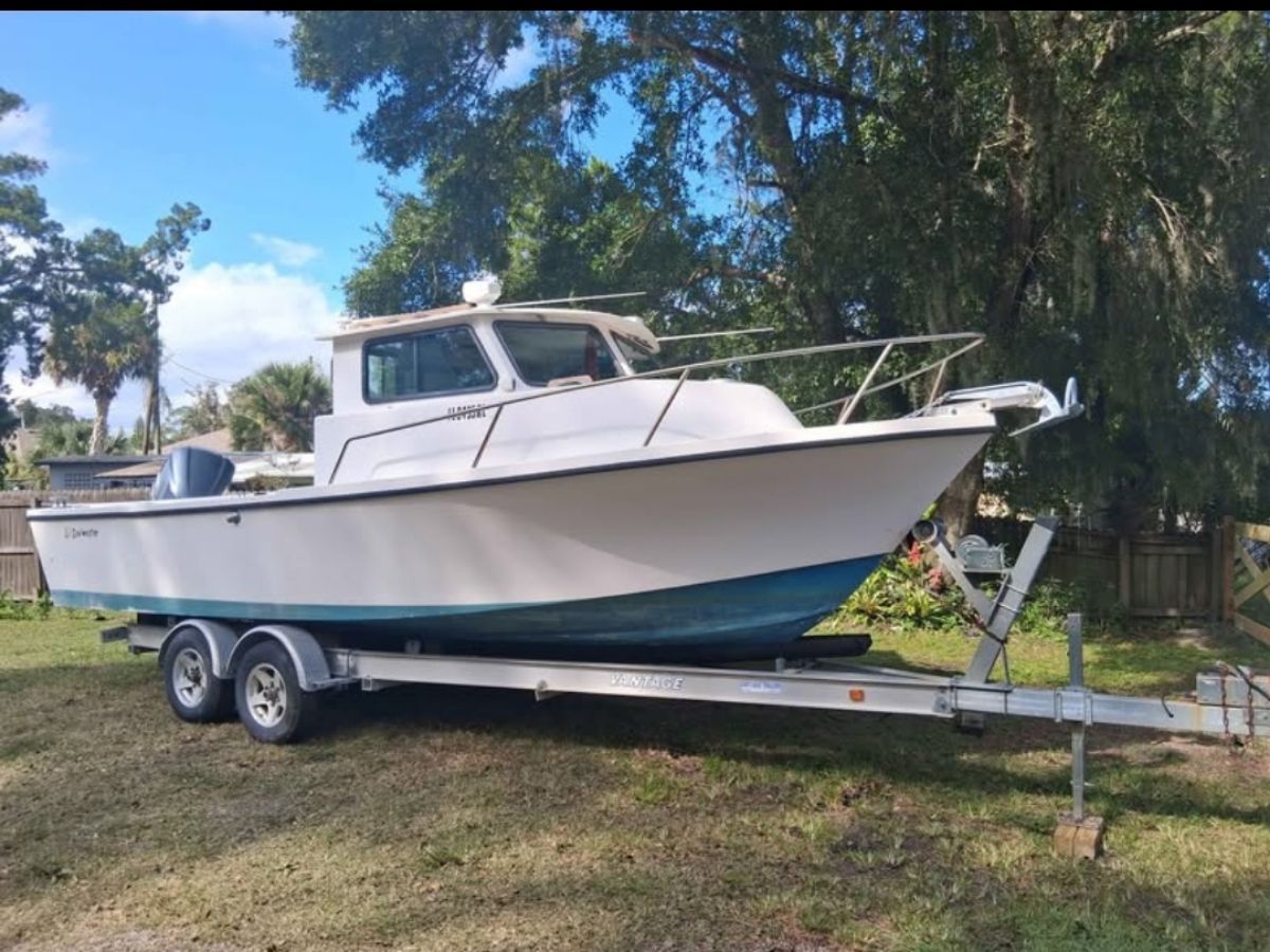 1987 Parker Sou'wester boat on trailer in a yard.