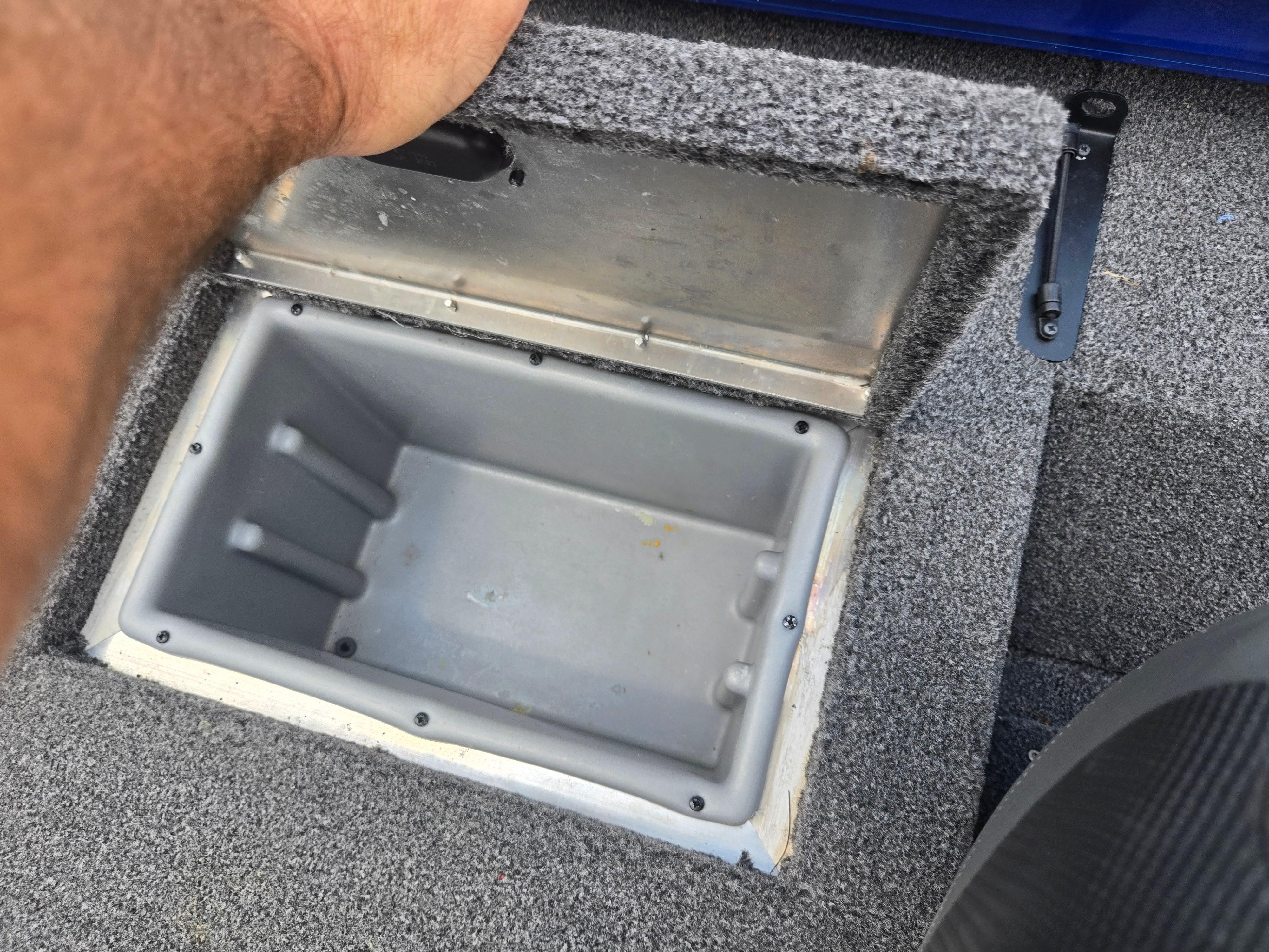 Open storage compartment in 2021 Lowe Stinger 188 boat, showing interior details.