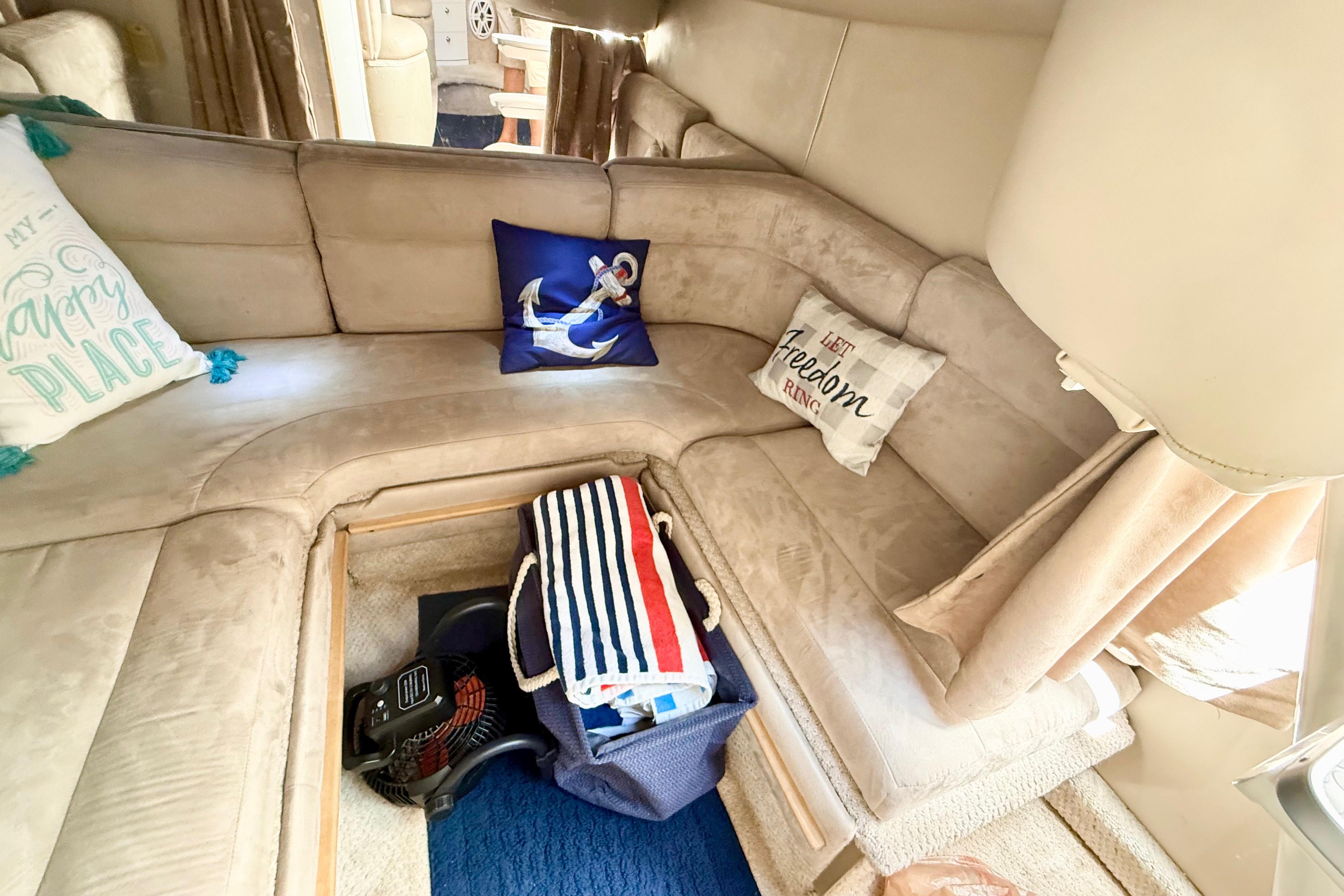 Interior of 1999 Chaparral Signature 300 boat with cozy seating and nautical-themed pillows.