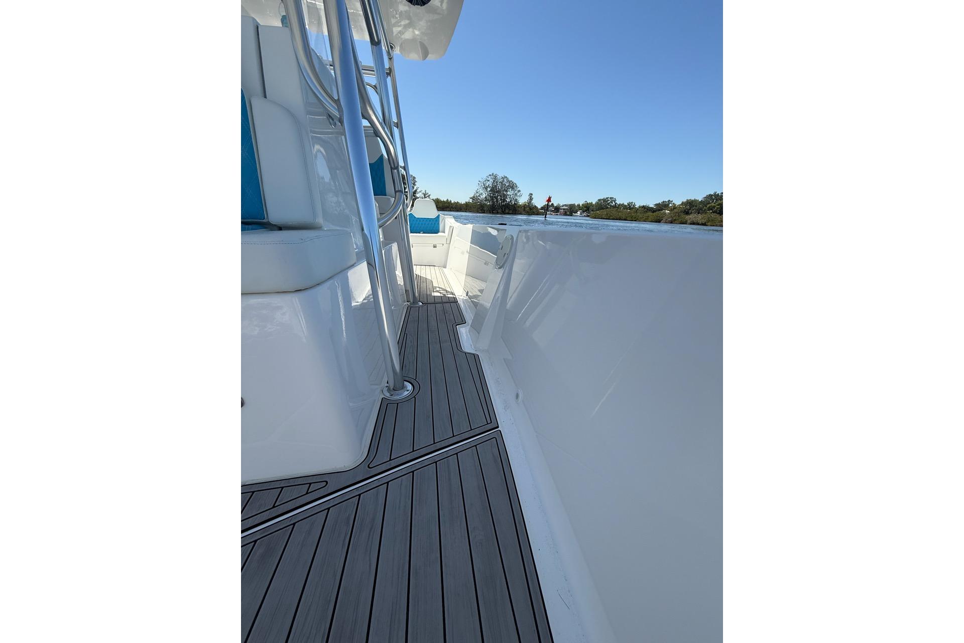 2021 Custom Infusion 34 CC boat deck with sleek design and blue seating.