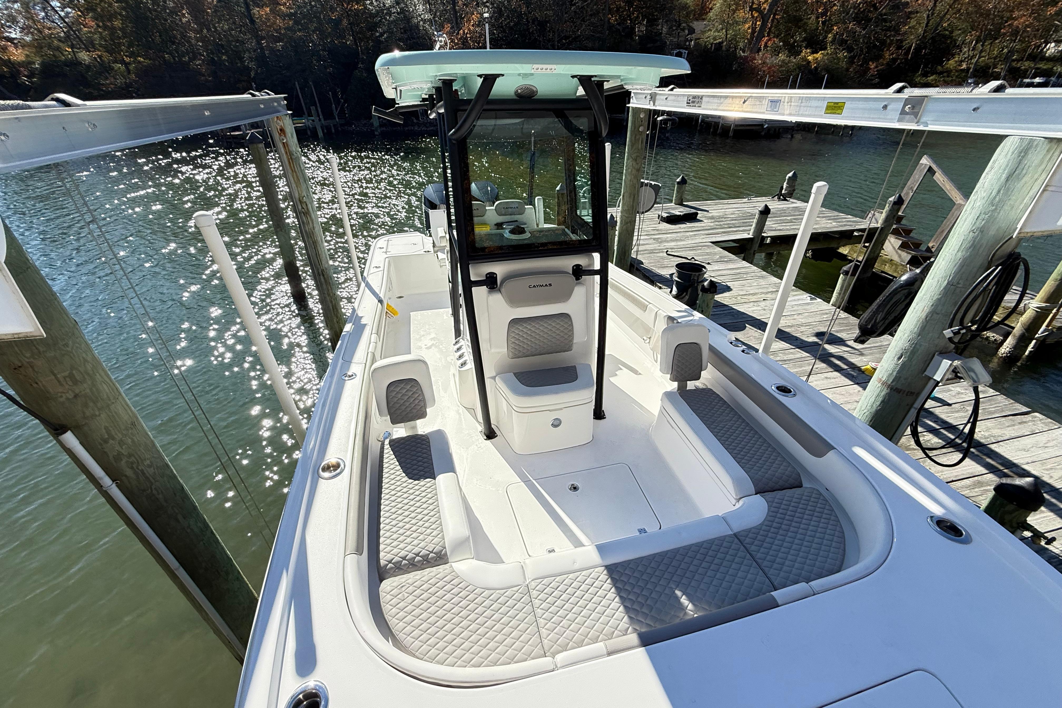 2023 Caymas 281 HB boat docked, featuring spacious seating and sleek design.
