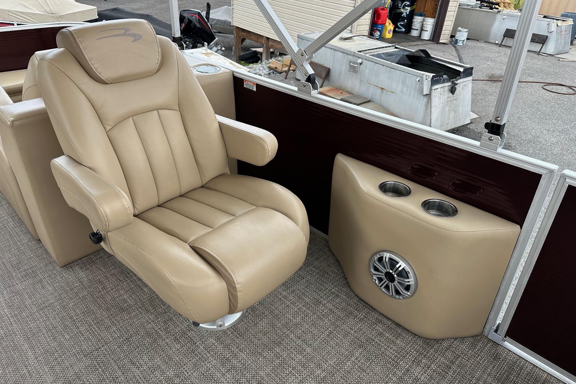 Luxurious seating and cup holders on a 2016 Bennington 24 SCWX boat interior.