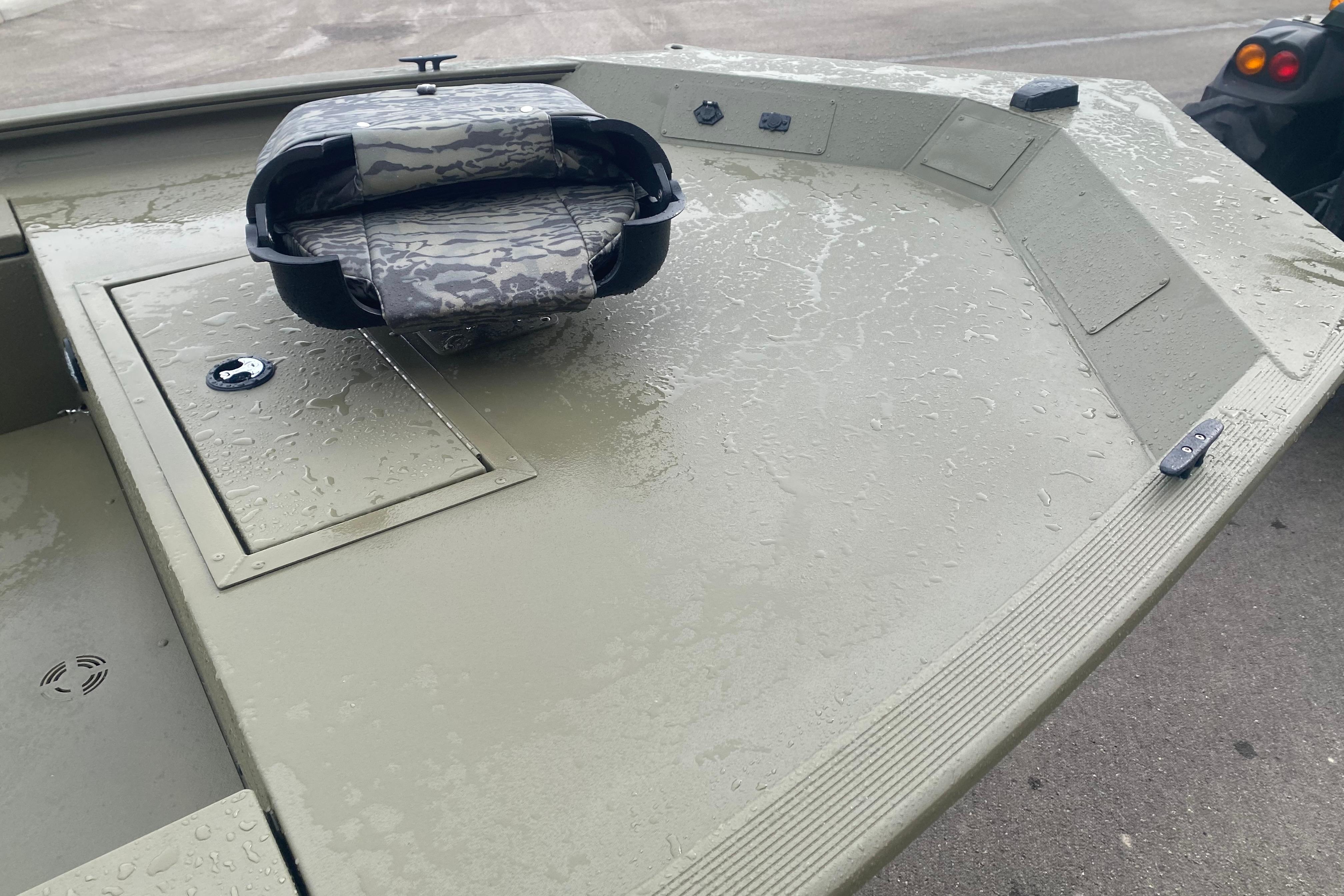 2026 Tracker Grizzly 1654 T Sportsman boat deck with camo seat and storage compartment.