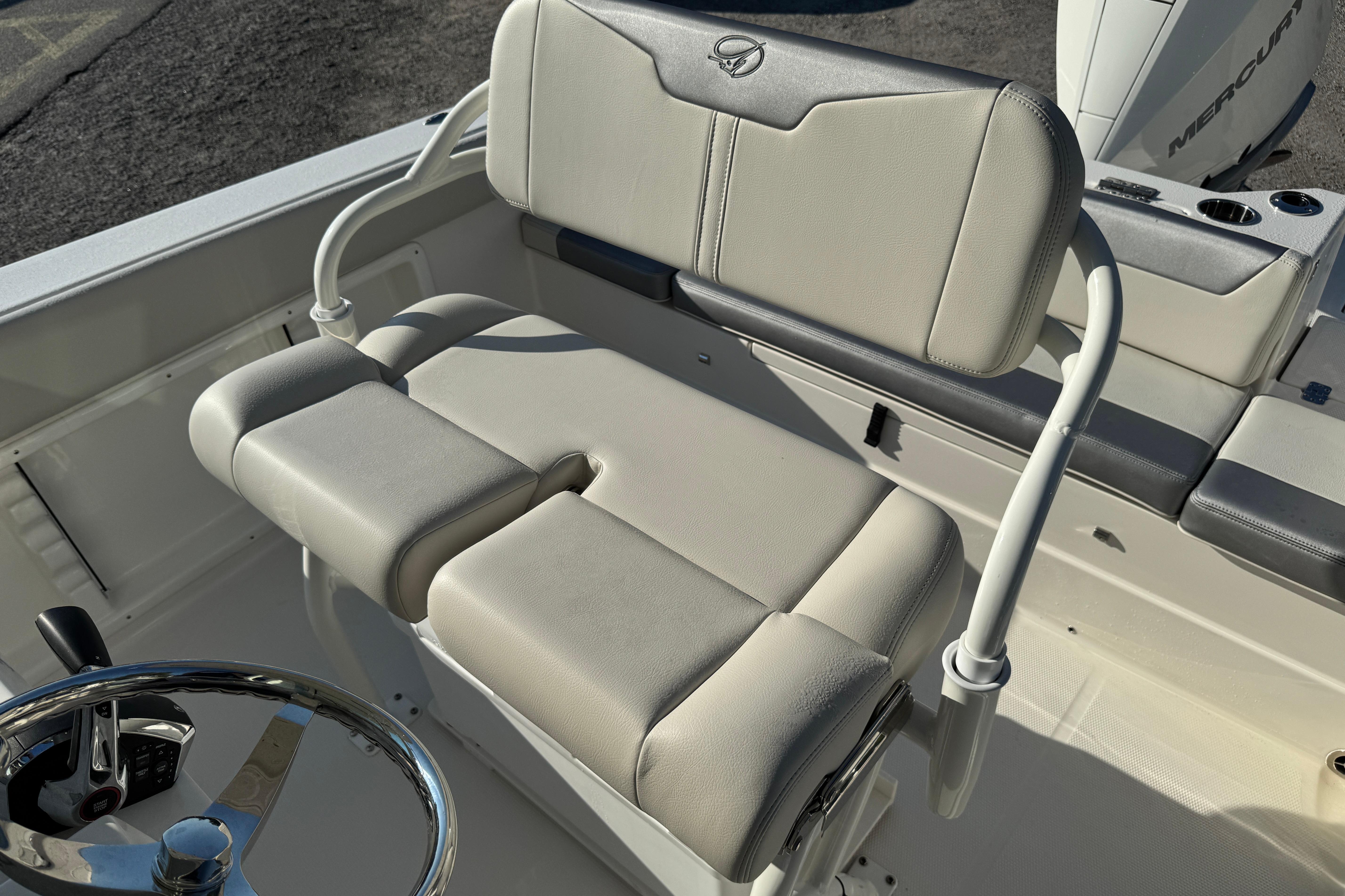 2026 Sailfish 232 CC boat interior with cushioned seating and steering wheel.