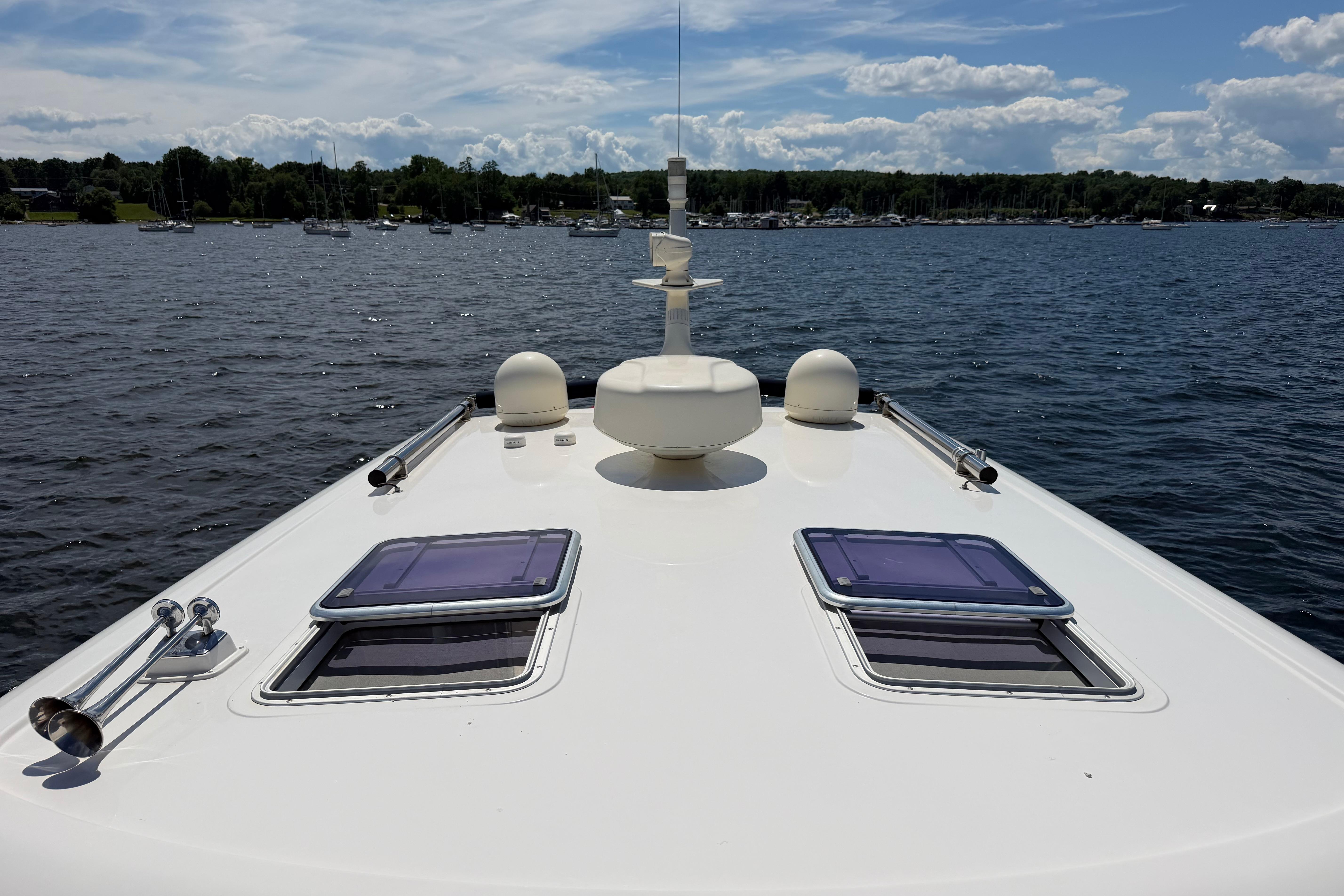 2015 Sabre 38 Salon Express yacht deck on a sunny day, overlooking calm waters.
