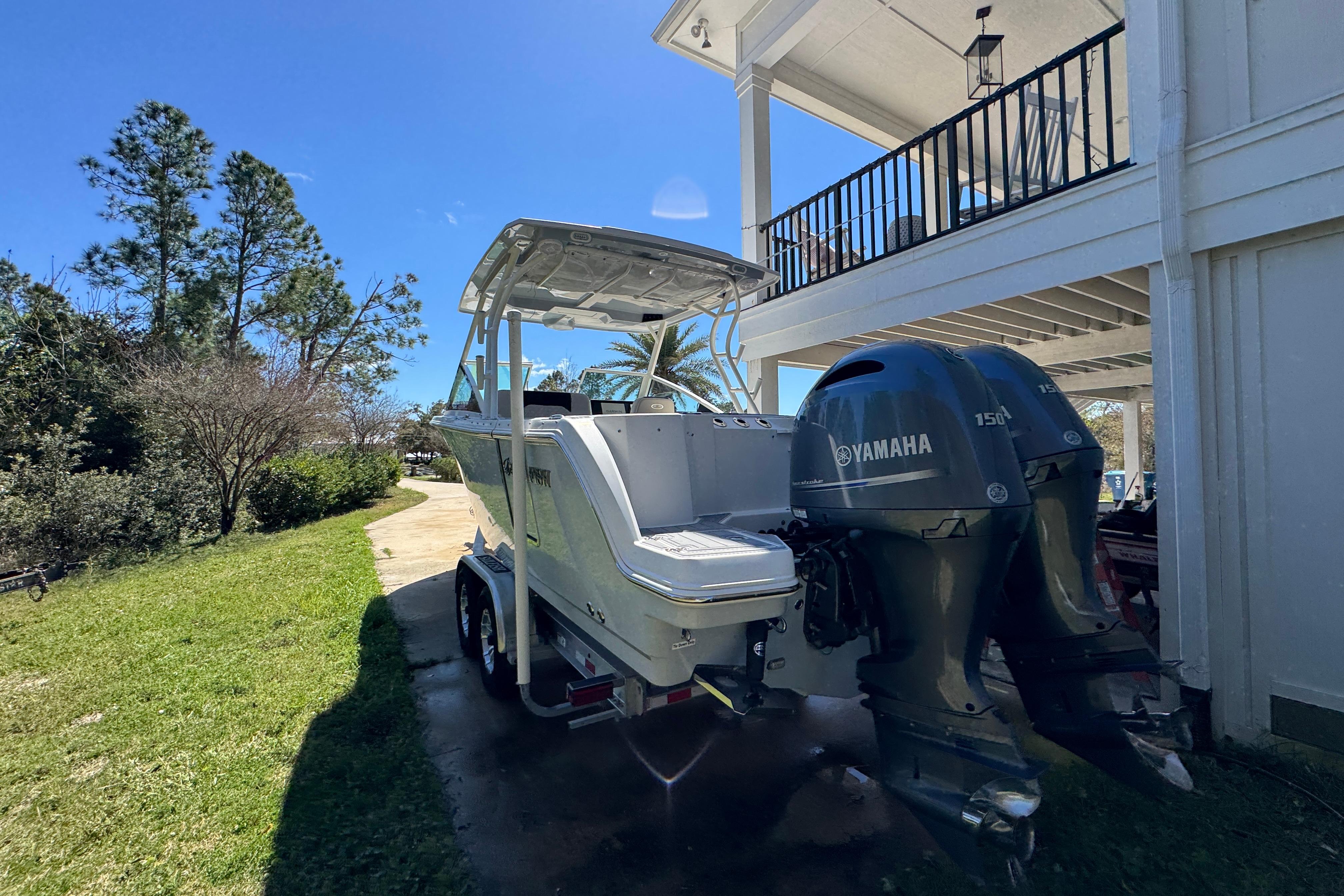 2022 Sailfish 276 DC boat with Yamaha engines parked outdoors.